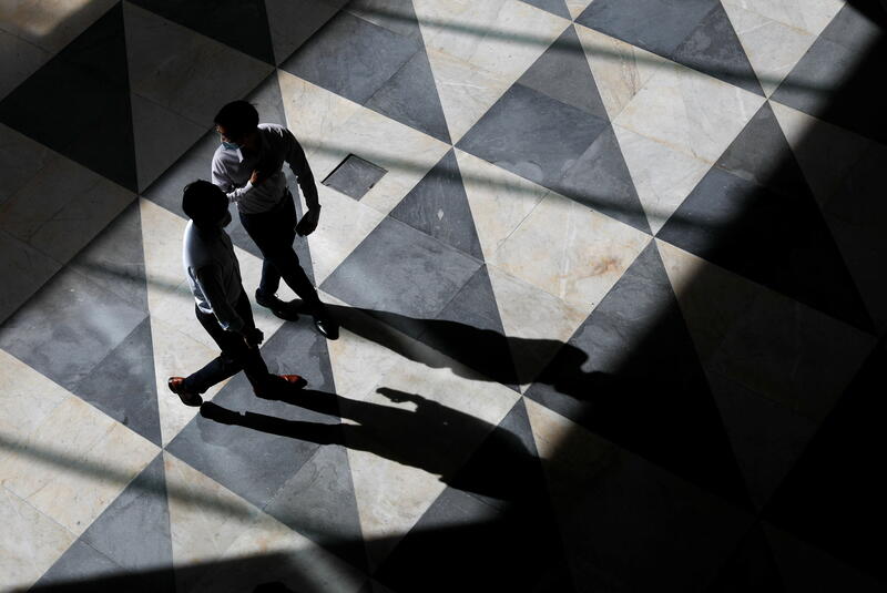 Office workers are seen at a largely empty central business district as Singapore returns to the work-from-home regime due to surging cases in the coronavirus disease (COVID-19) outbreak, in Singapore