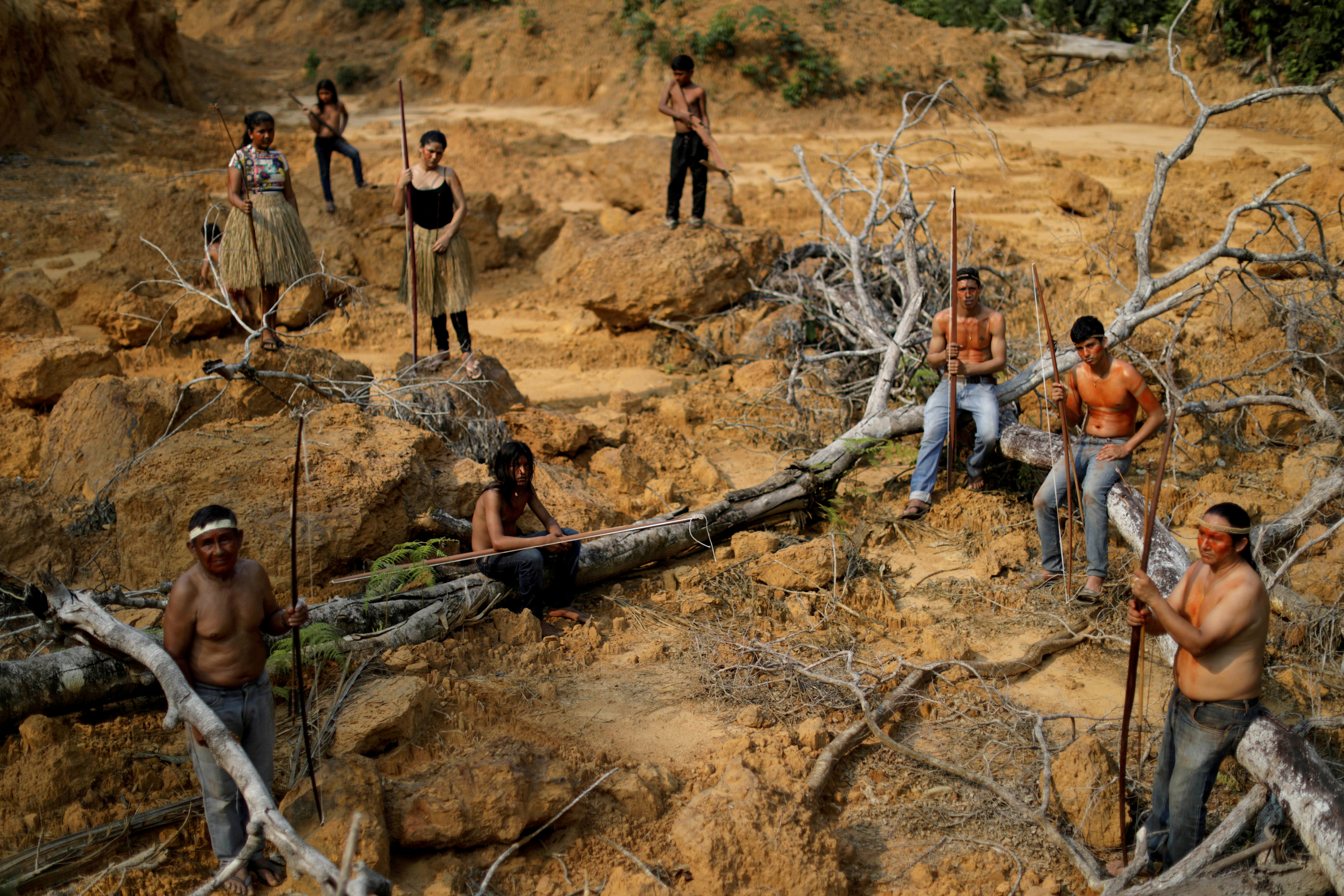 Indigenous people from the Mura tribe show a deforested area in unmarked indigenous lands inside the Amazon rainforest near Humaita