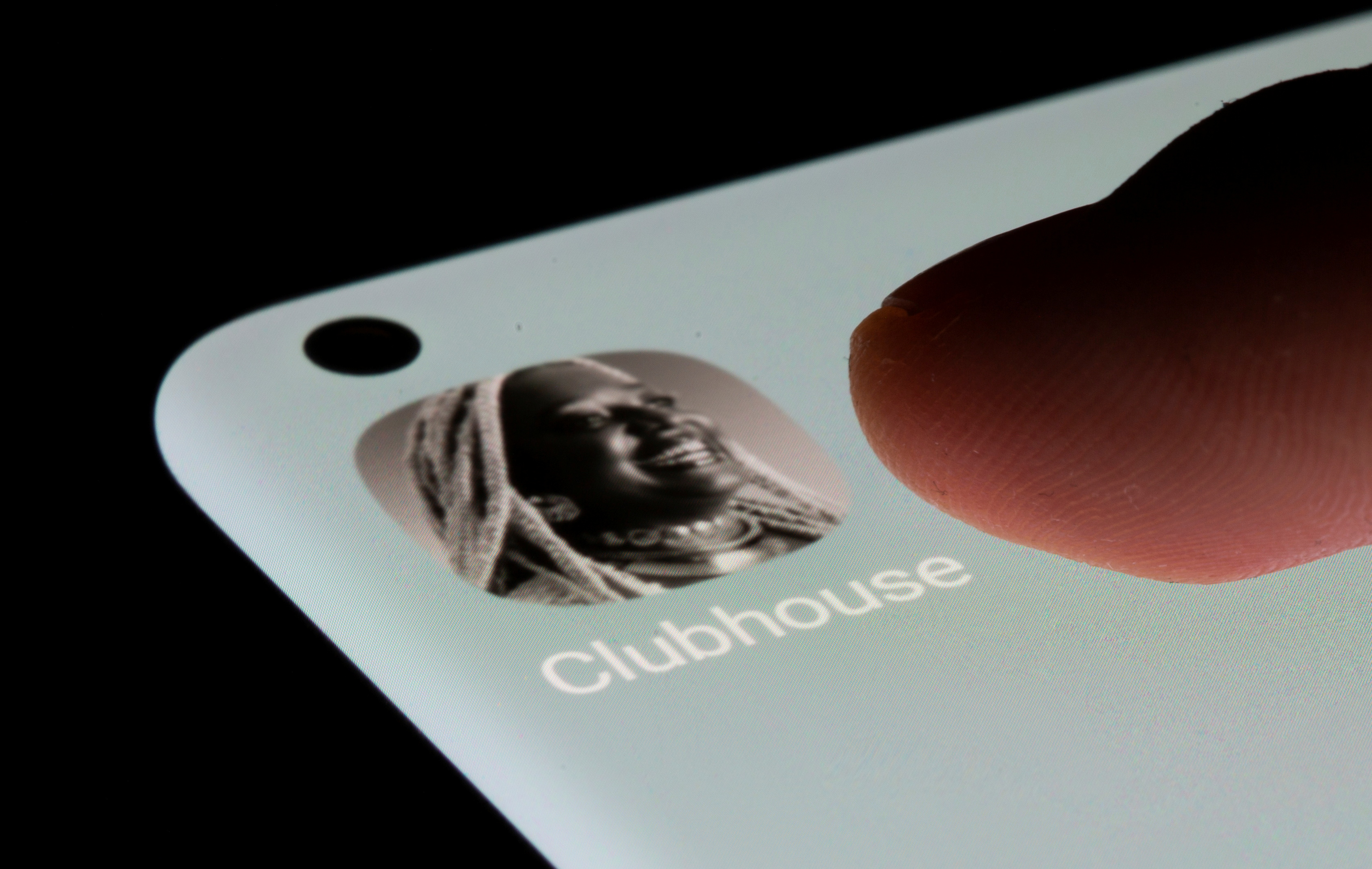 Clubhouse app is seen on a smartphone in this illustration