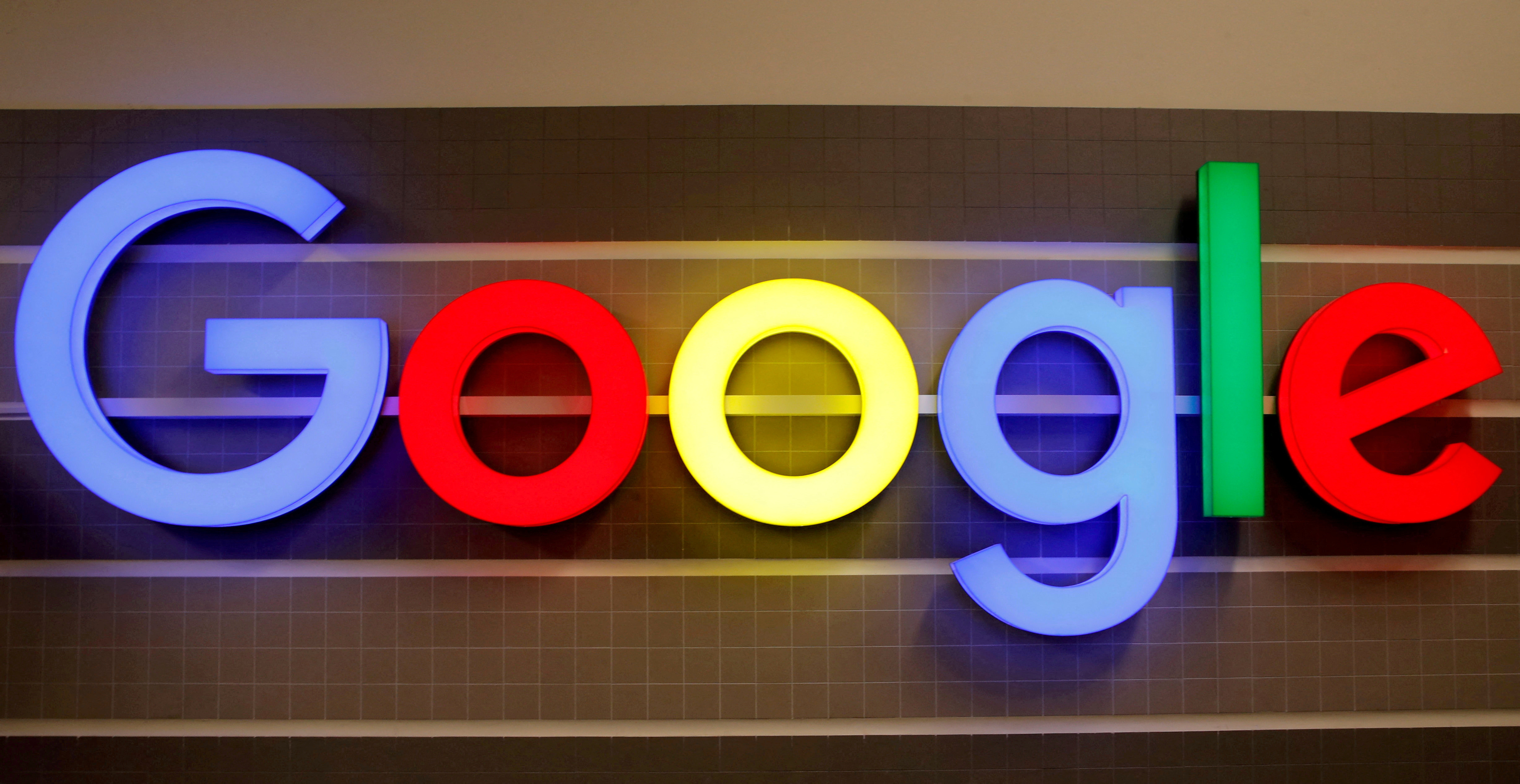 FILE PHOTO: FILE PHOTO: An illuminated Google logo is seen inside an office building in Zurich