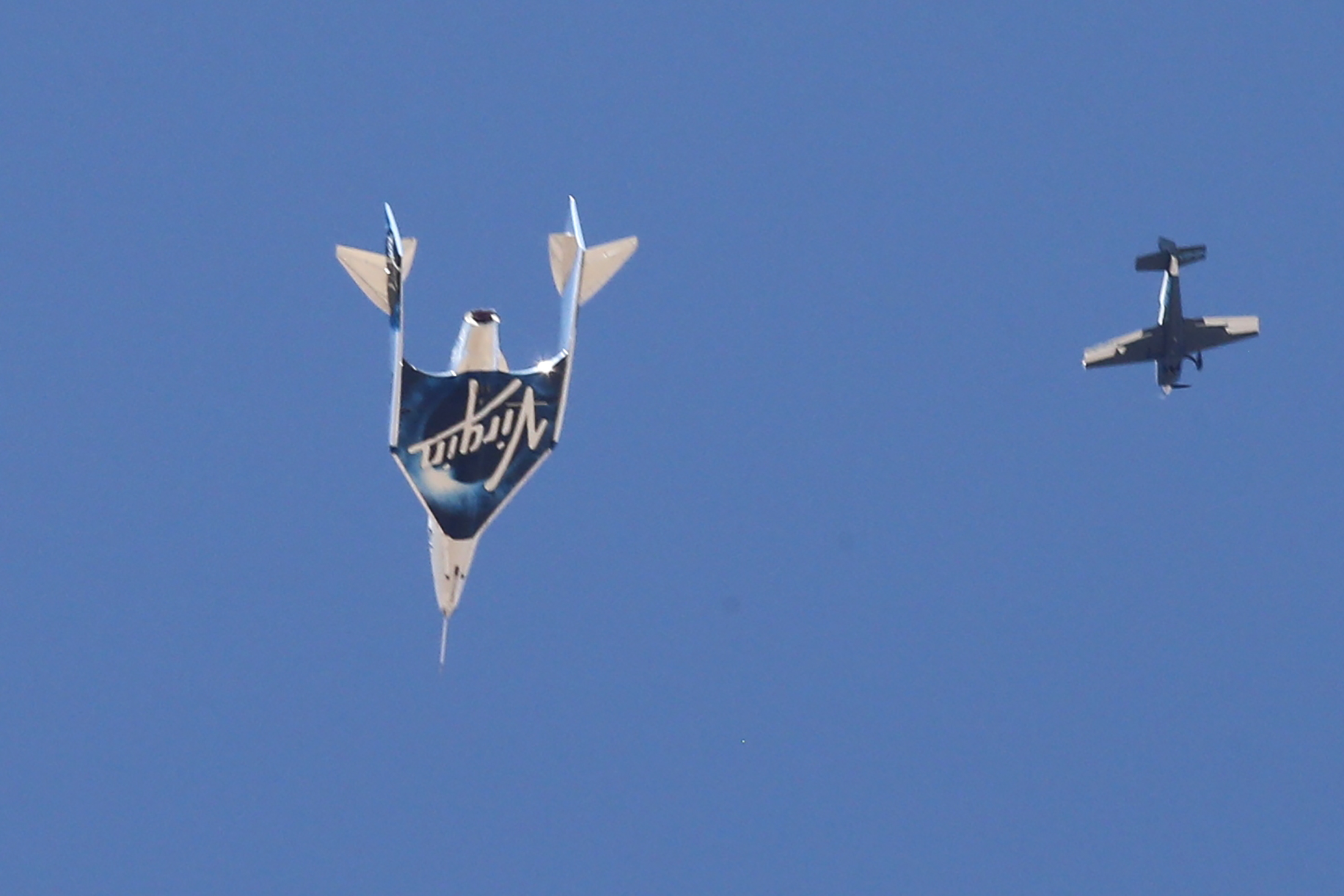 Virgin Galactic's passenger rocket plane VSS Unity descends after reaching the edge of space above Spaceport America