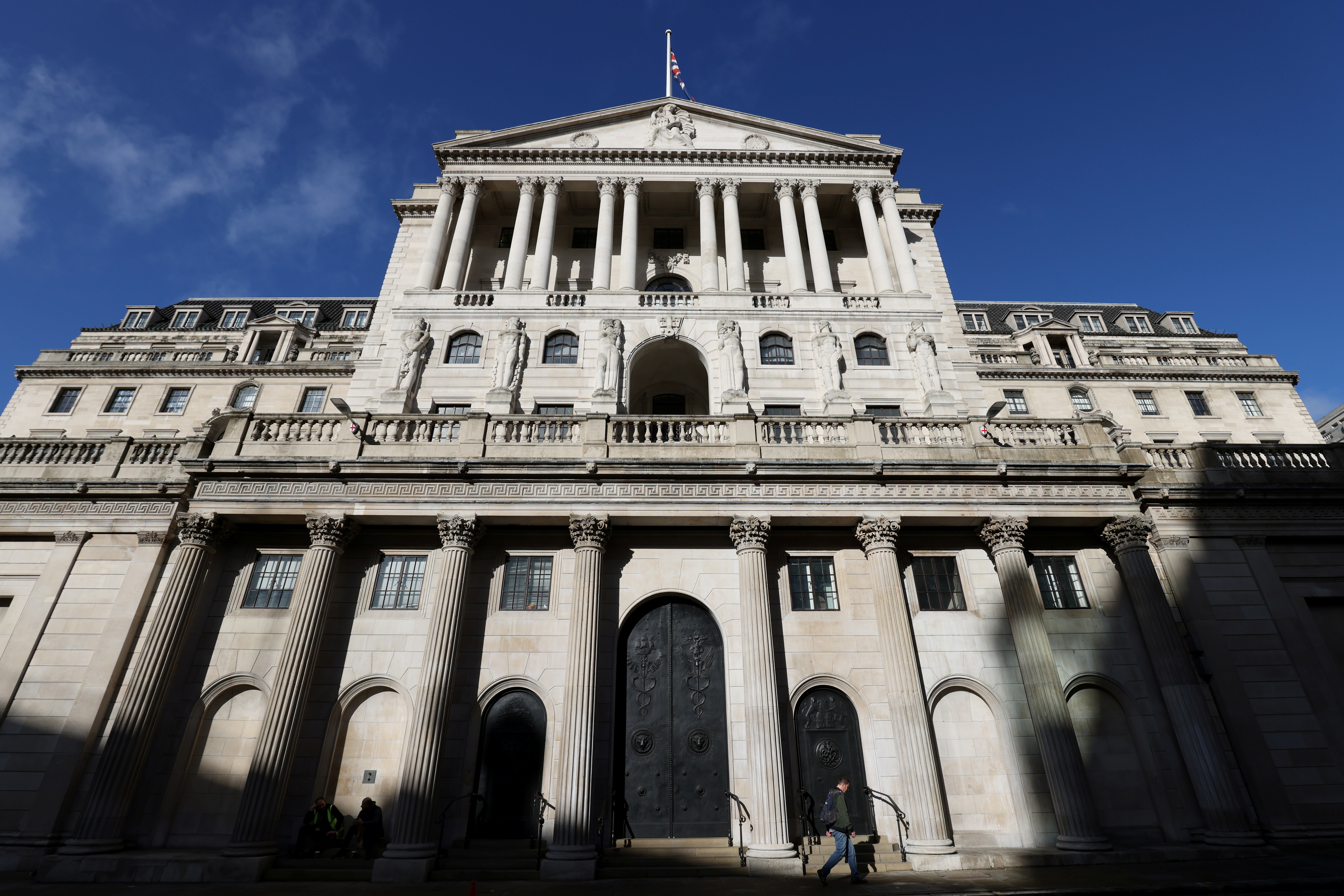 A person walks past the Bank of England, in London