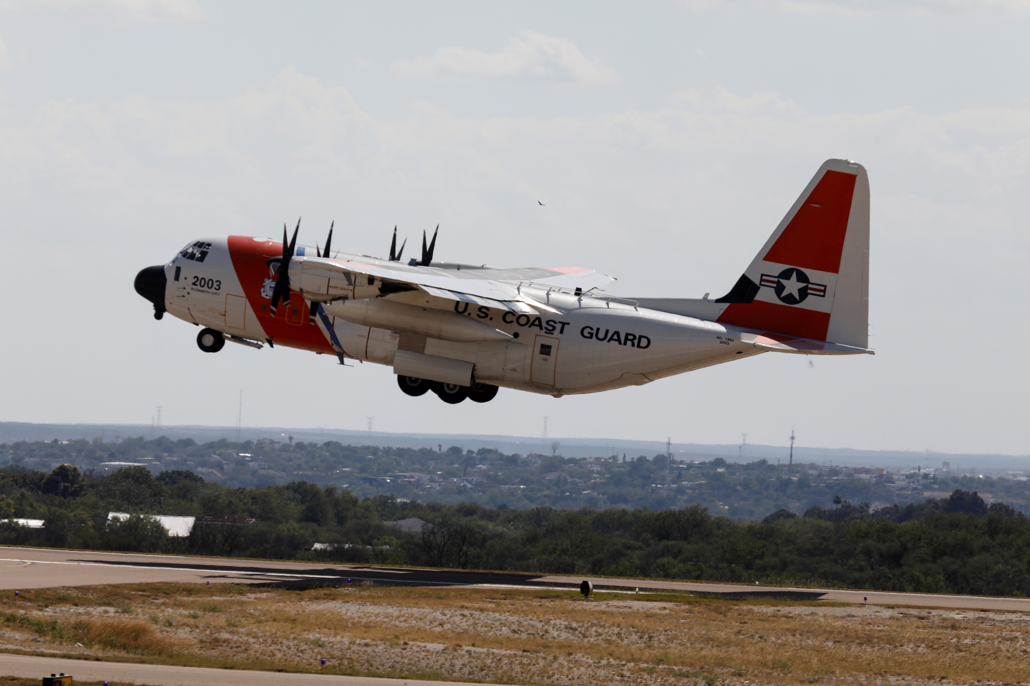 A U.S. Coast Guard airplane with migrants on board departs the Del Rio International Airport as U.S. authorities accelerate removal of migrants at border with Mexico, in Del Rio
