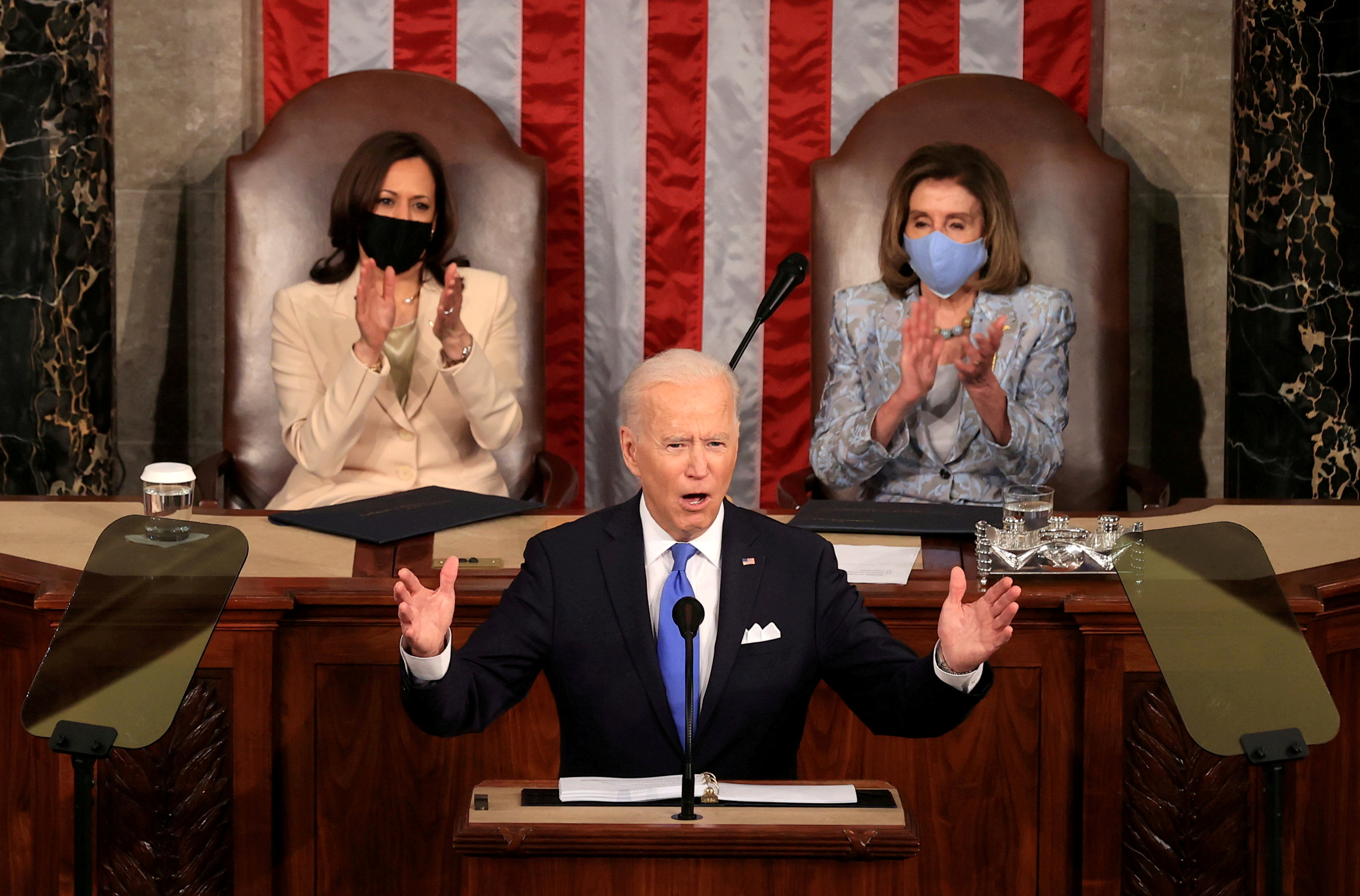 U.S. President Joe Biden addresses a joint session of Congress as Vice President Kamala Harris and Speaker of the House U.S. Rep. Nancy Pelosi (D-CA) applaud, at the U.S. Capitol in Washington, DC, U.S. April 28, 2021. Chip Somodevilla/Pool via REUTERS