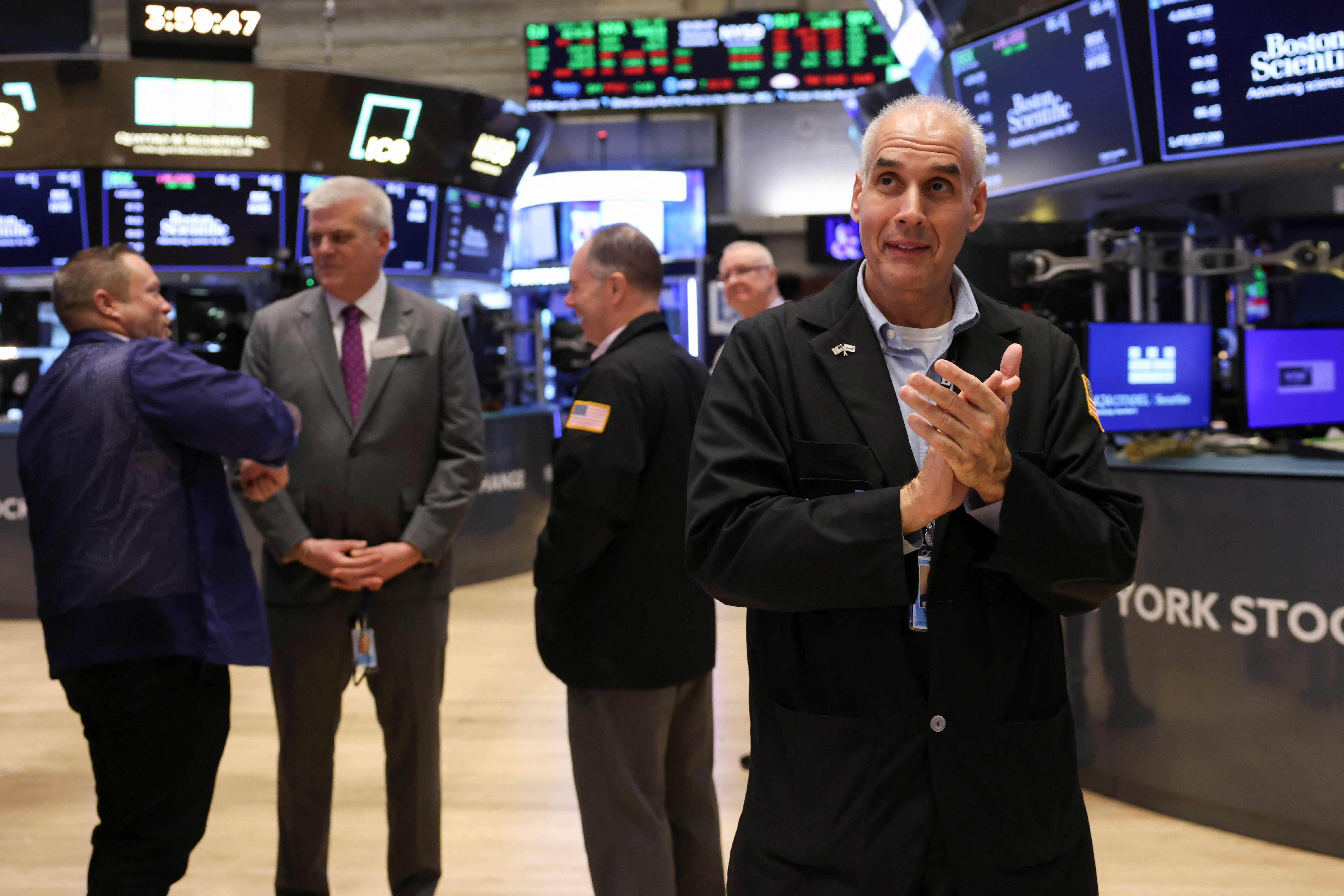 Traders work on NYSE floor