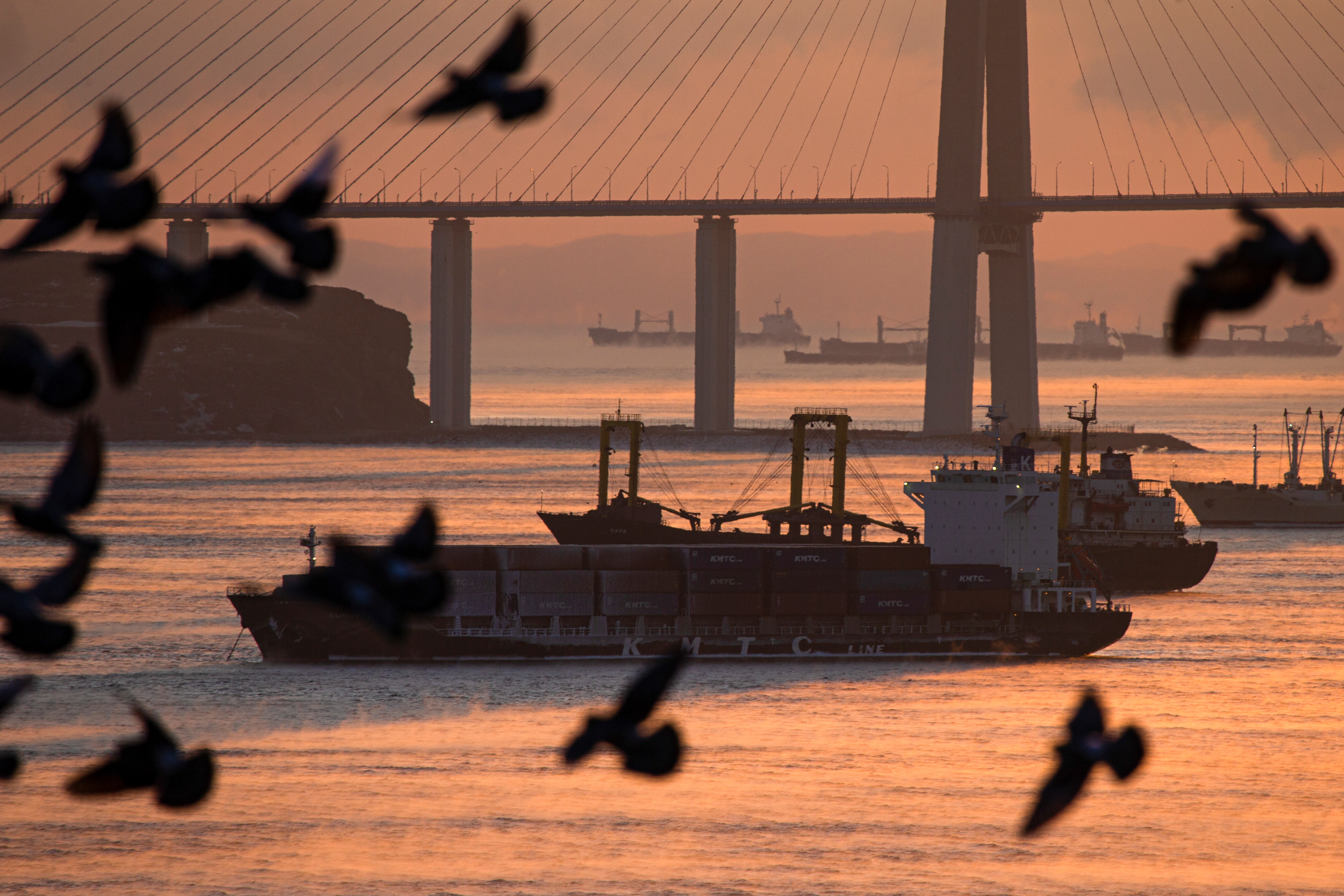Ships are seen near the Russky Bridge connecting to the Russky Island at a cold day in far-eastern city of Vladivostok