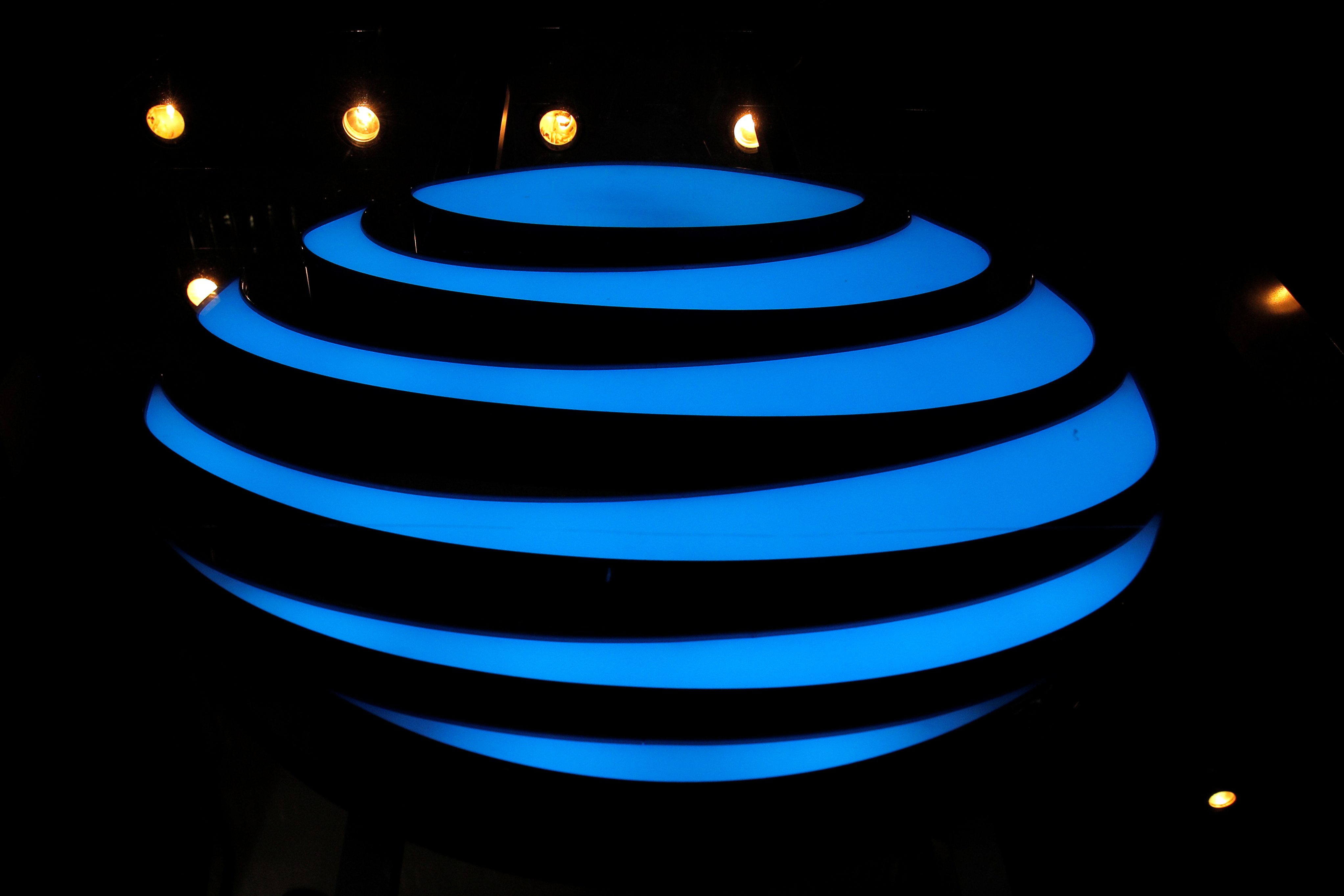 The AT&T logo is seen in a store window in New York