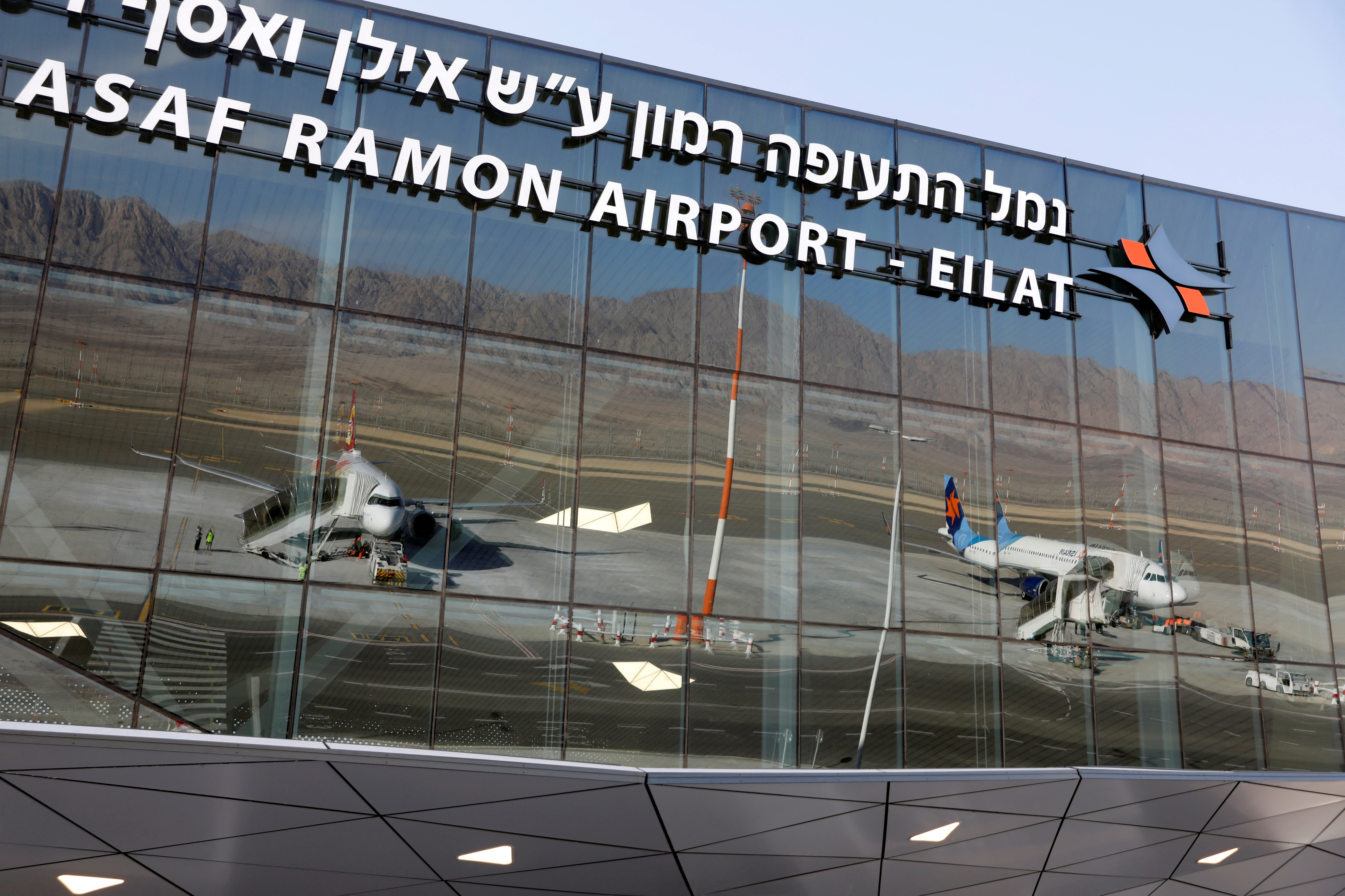 Planes are reflected in the facade of the Ramon International Airport after an inauguration ceremony for the new airport, just outside the southern Red Sea resort city of Eilat, Israel