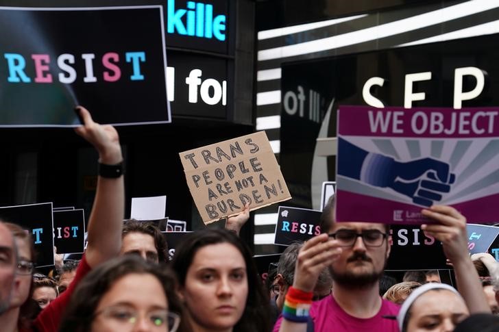 People protest U.S. President Donald Trump's announcement that he plans to reinstate a ban on transgender individuals from serving in any capacity in the U.S. military, in Times Square, in New York City