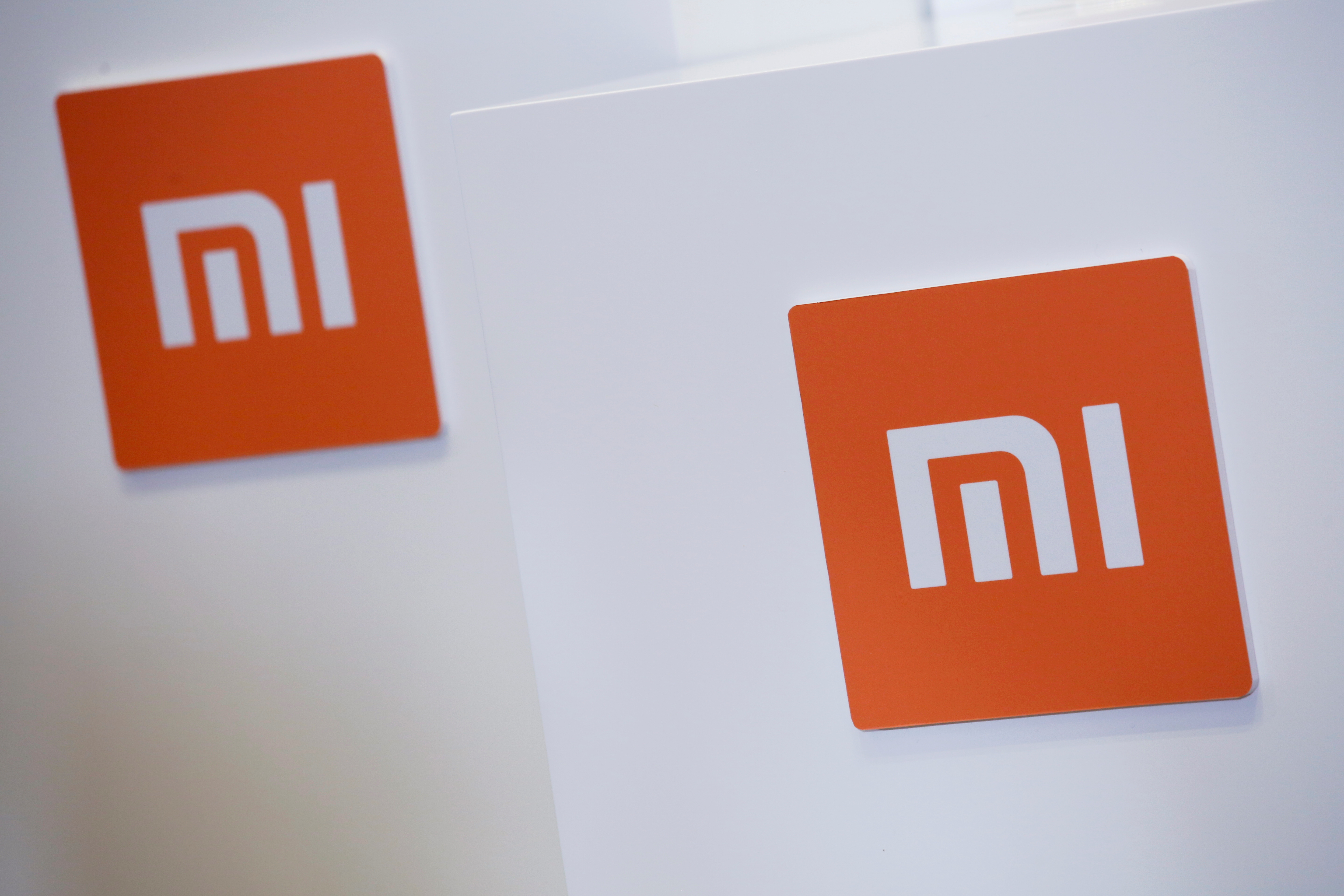 Xiaomi logos are displayed during a news conference in Hong Kong