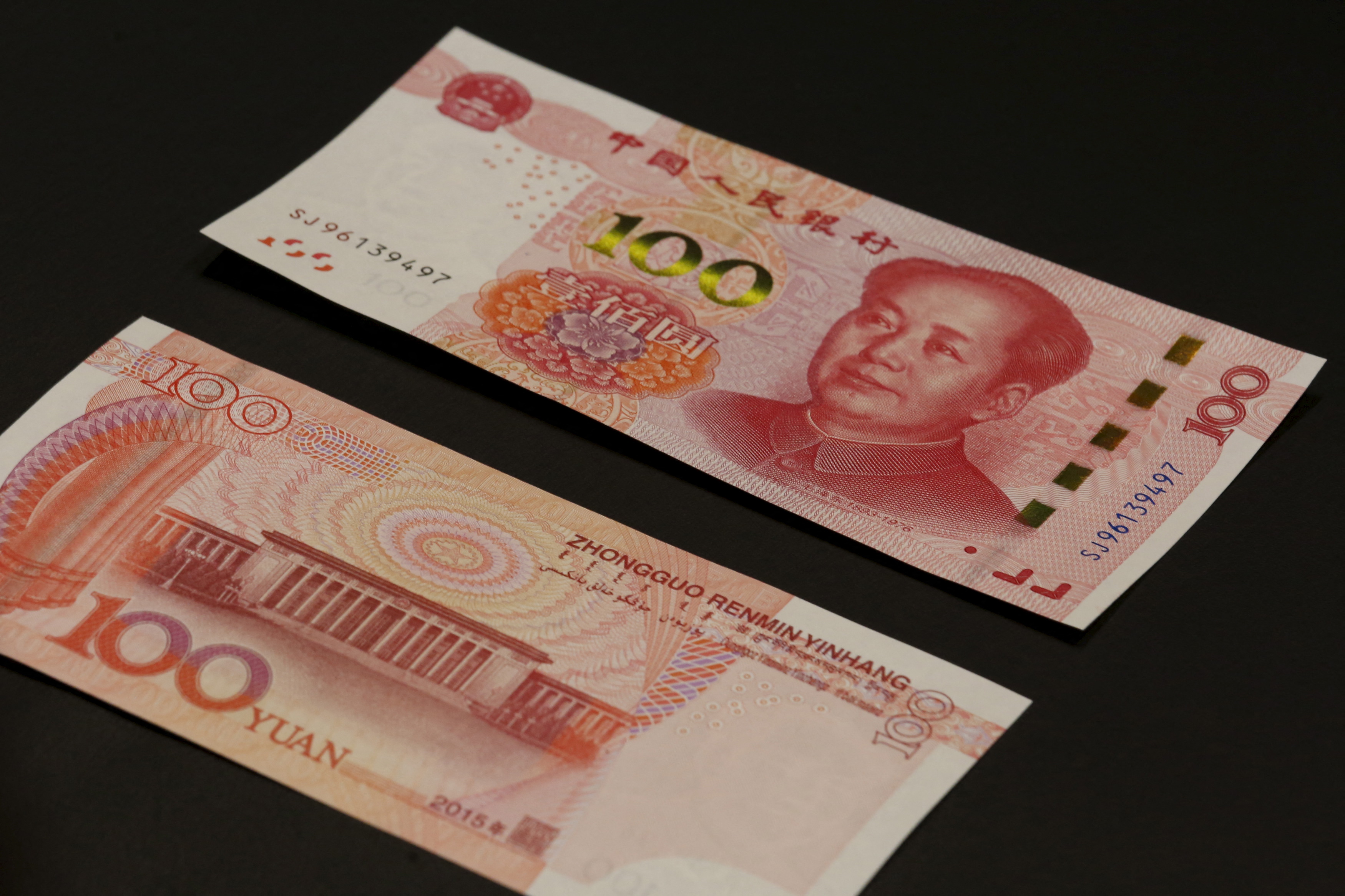 The 2015 edition of the 100 renminbi notes are displayed at the Bank of China Tower in Hong Kong