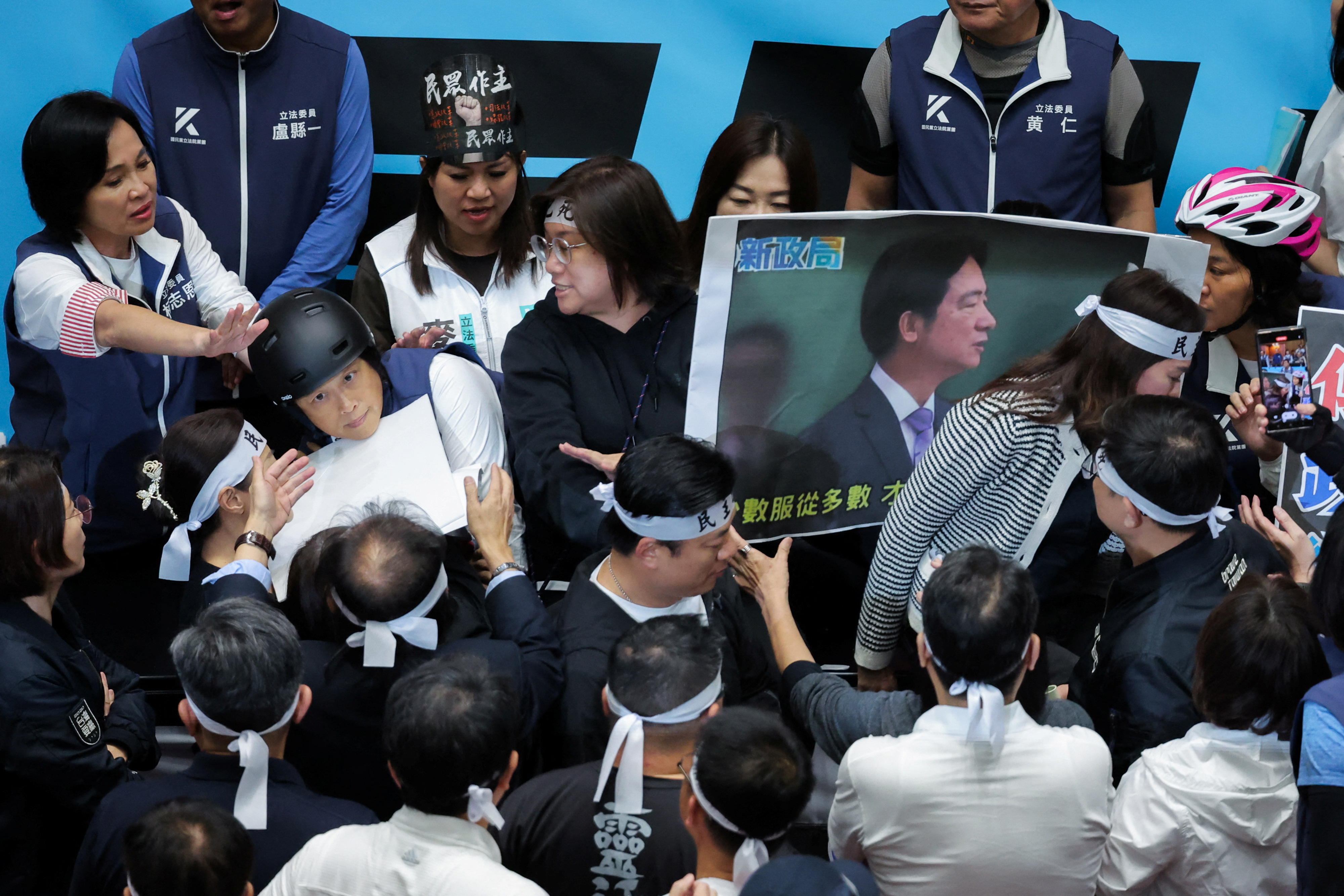 Lawmakers protest and fight during a parliamentary session in Taipei