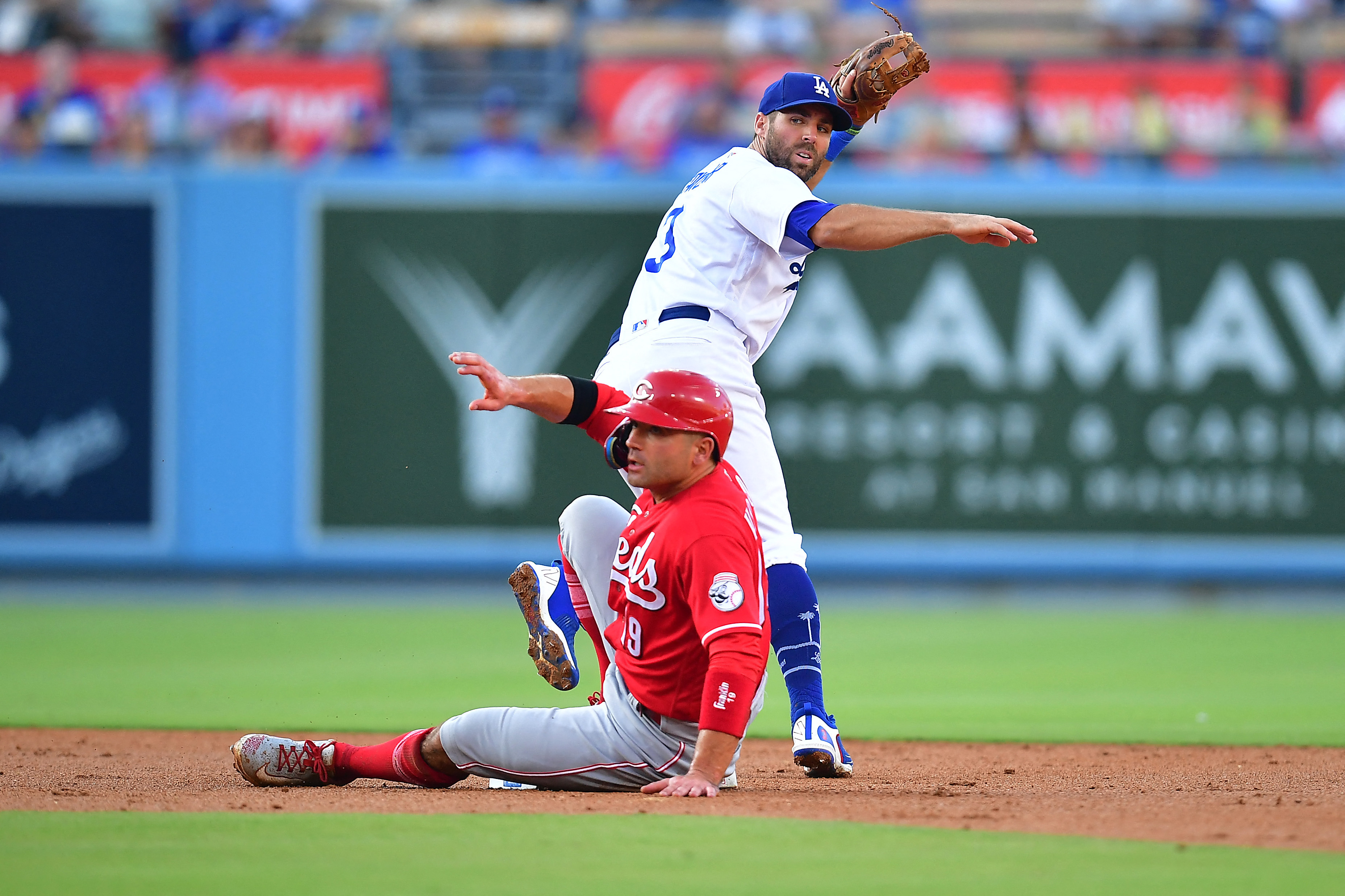 Apple TV - Los Angeles Dodgers player Max Muncy. He is wearing a white  jersey with Dodgers written across the middle and the number 13 on the left  side. He has white