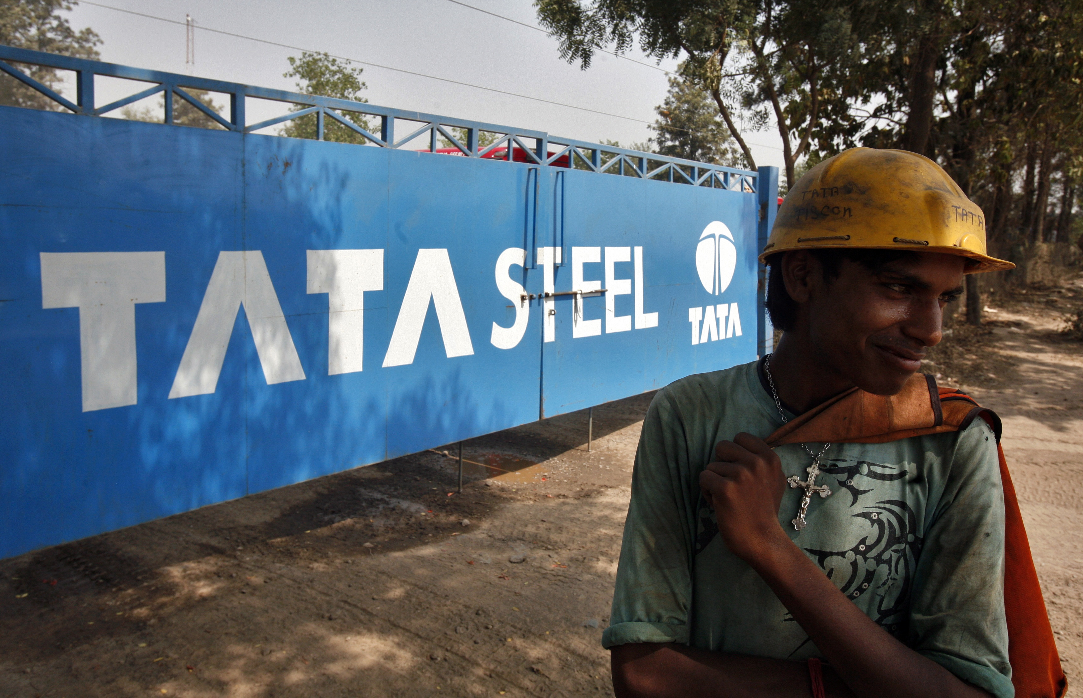 Labourer stands outside a Tata Steel stockyard in the northern Indian city of Chandigarh