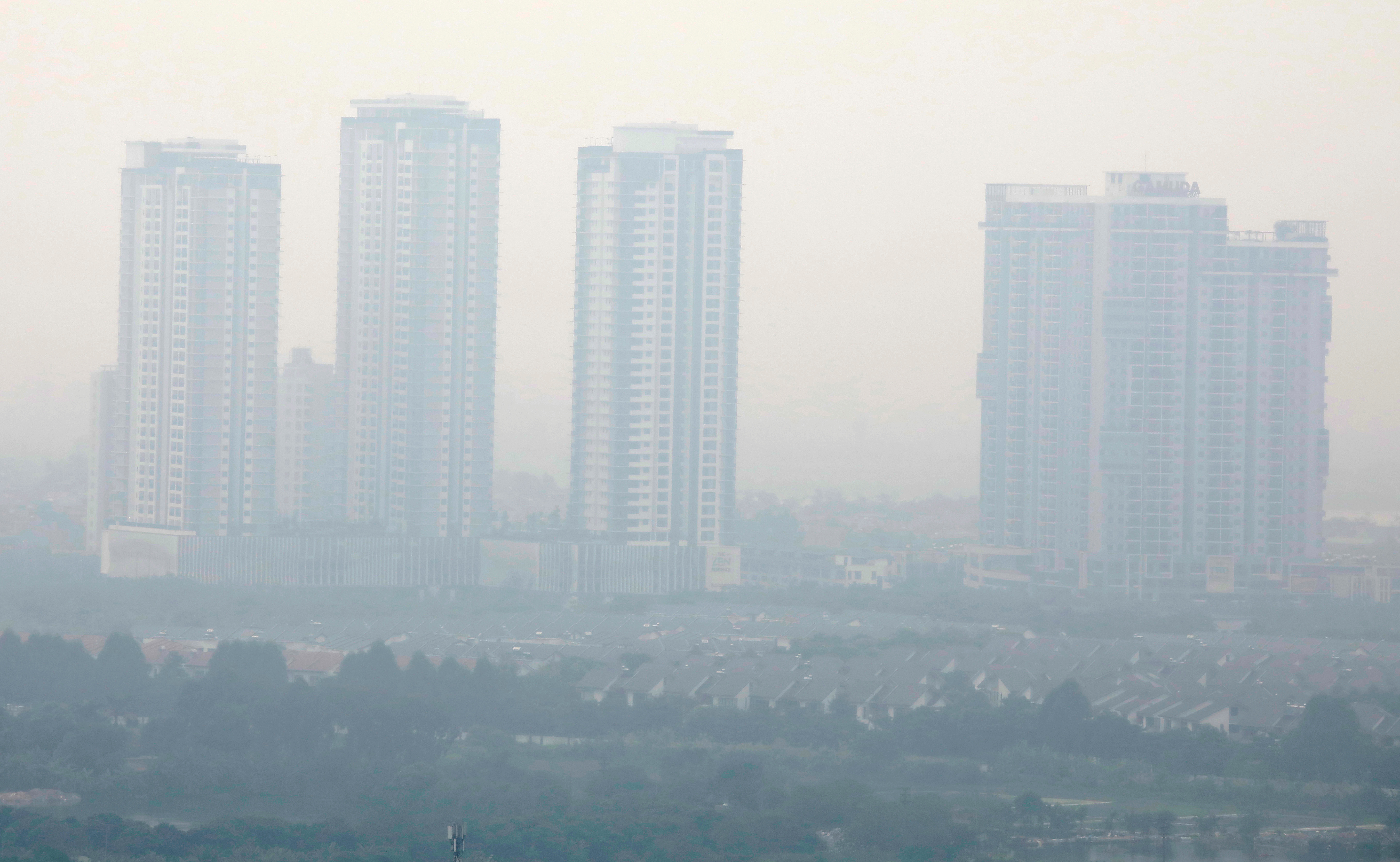 High-rise buildings are seen shrouded as the air quality continues to be "unhealthy" in Hanoi