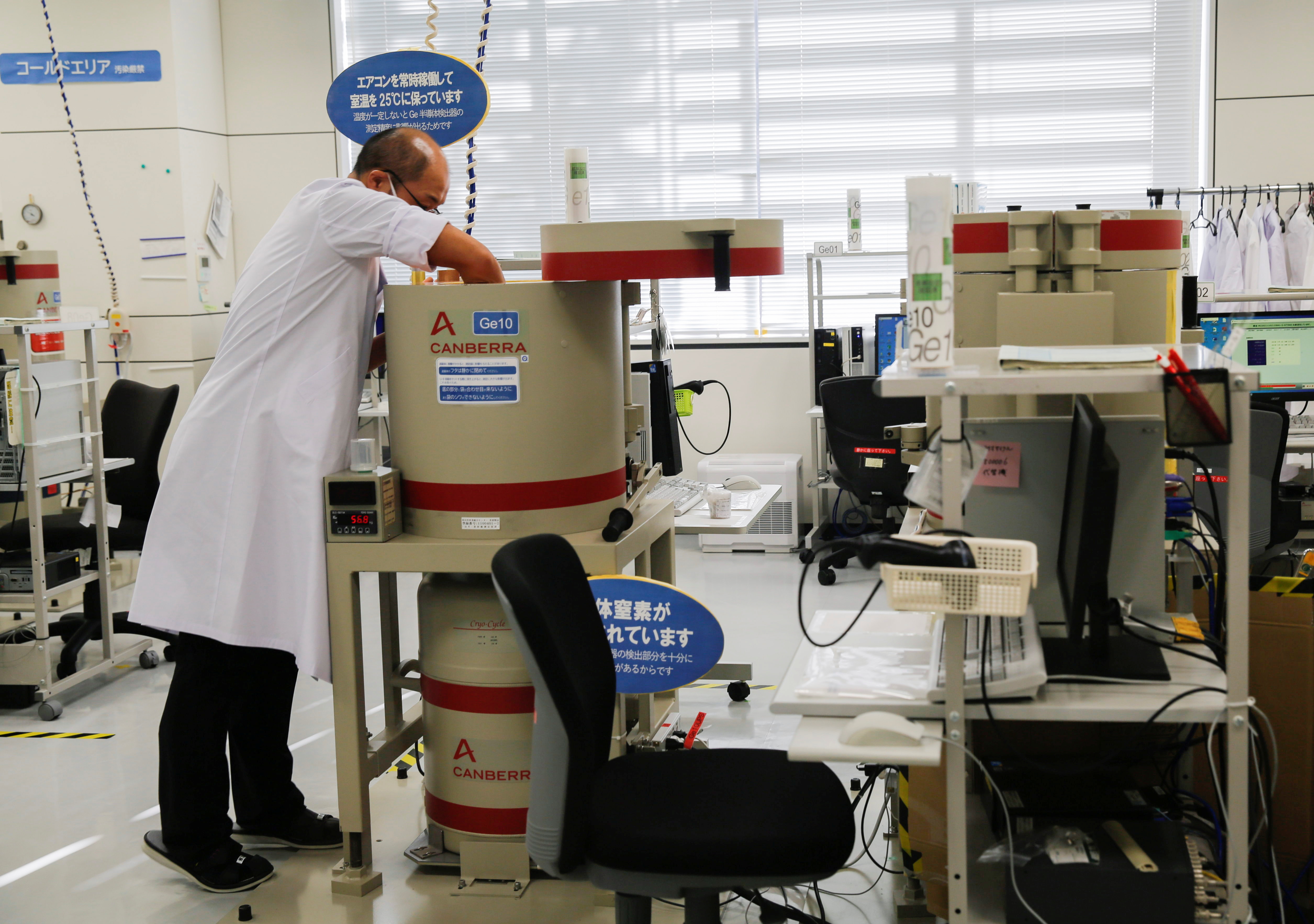 A laboratory technician prepare tests for cesium levels in beef from cattle bred in Fukushima in Koriyama, Japan