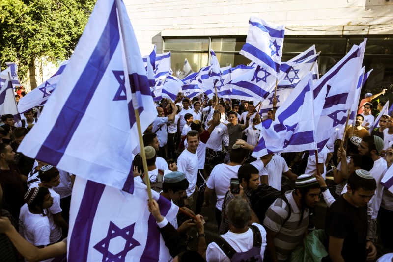 Israelis wave Israeli flags outside Jerusalem's Old City