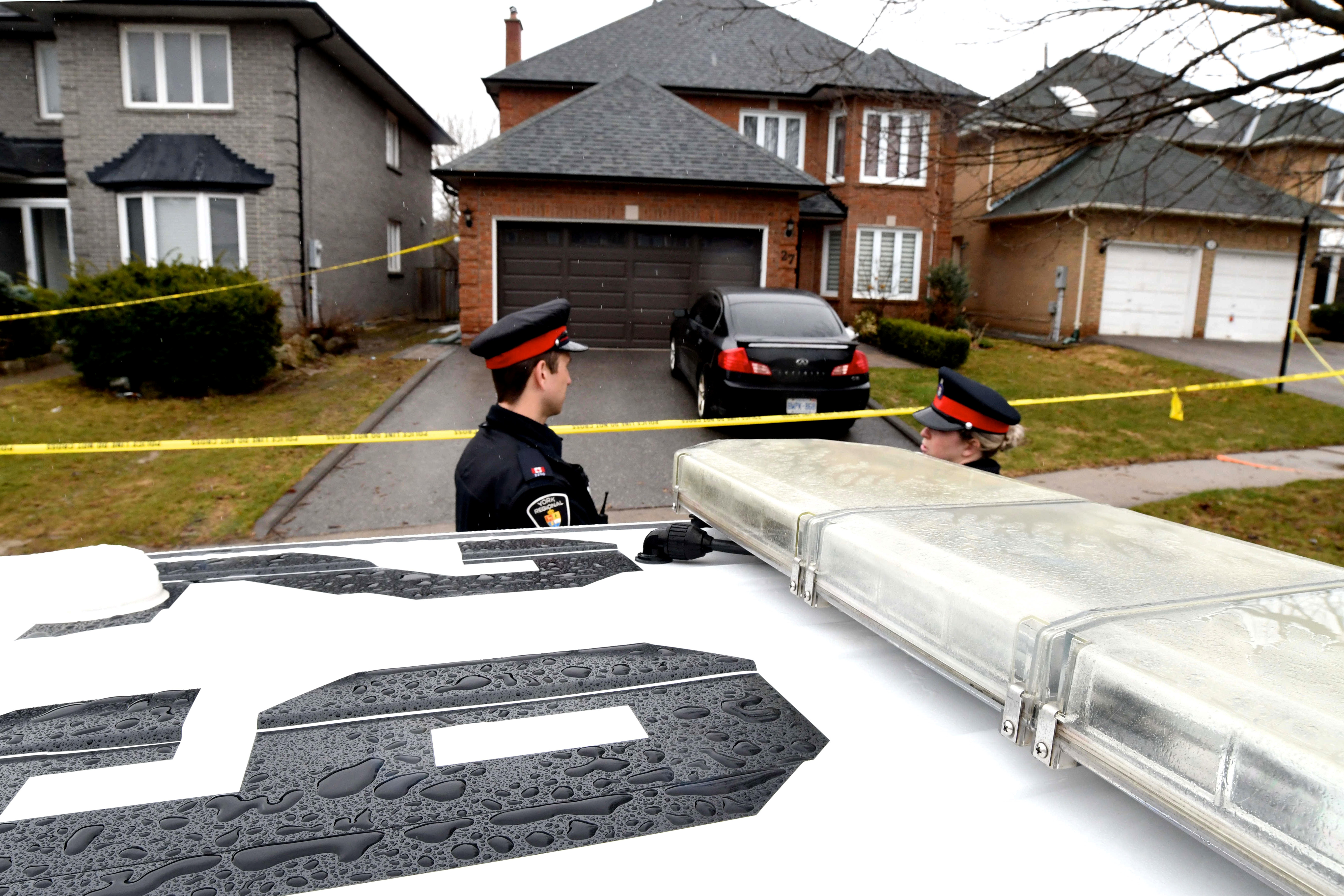 Police officers wait for a search warrant in front of the home of Alek Minassian in Richmond Hill