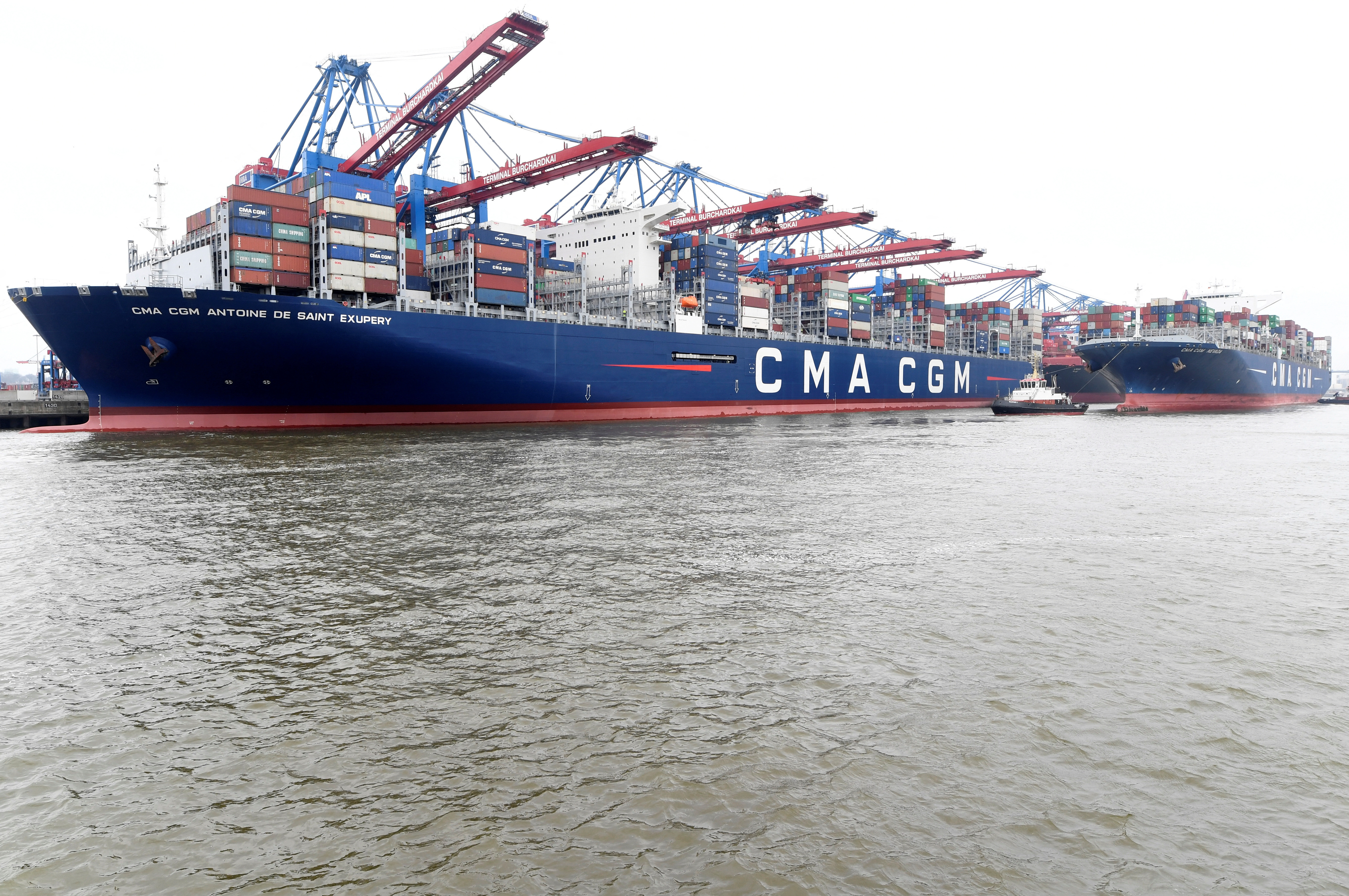 Container ships CMA CGM Antoine de Saint Exupery and CMA CGM Nevada are moored at the loading terminal in the port of Hamburg
