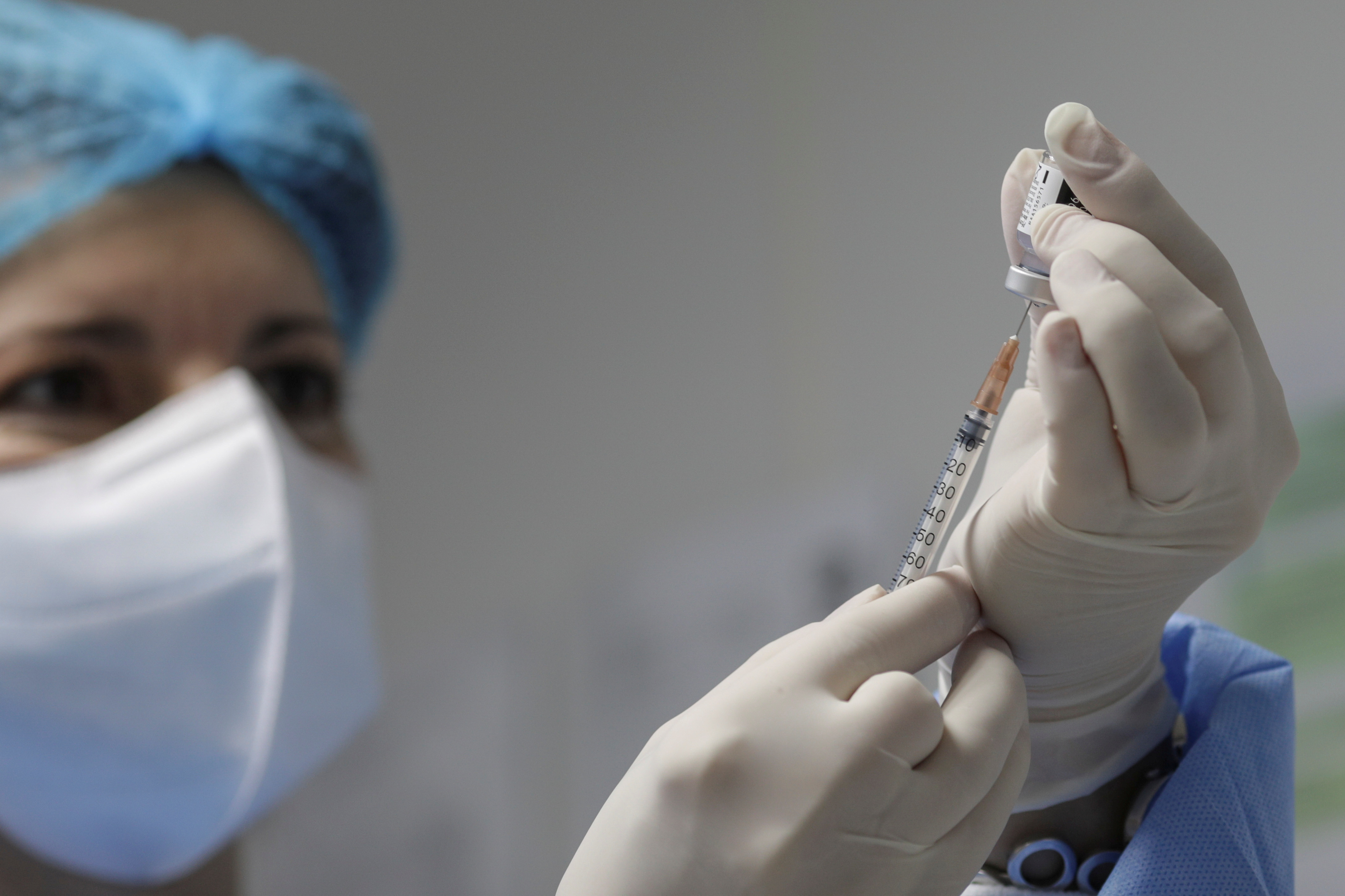 A nurse prepares a dose of the Pfizer-BioNTech coronavirus disease (COVID-19) vaccine