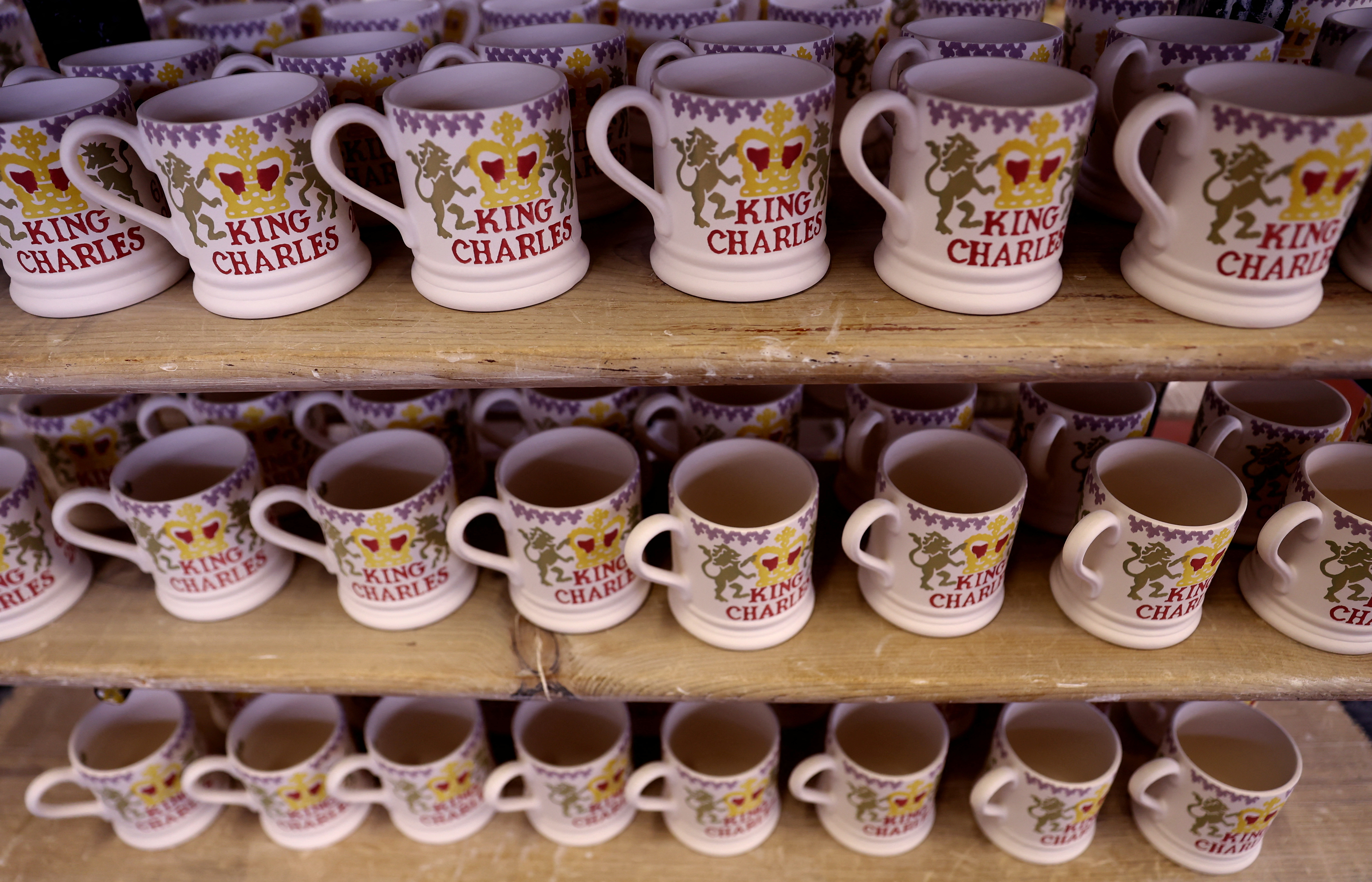 Decorated mugs commemorating the coronation of Britain's King Charles are seen at the Emma Bridgewater Factory, in Hanley, Stoke-on-Trent