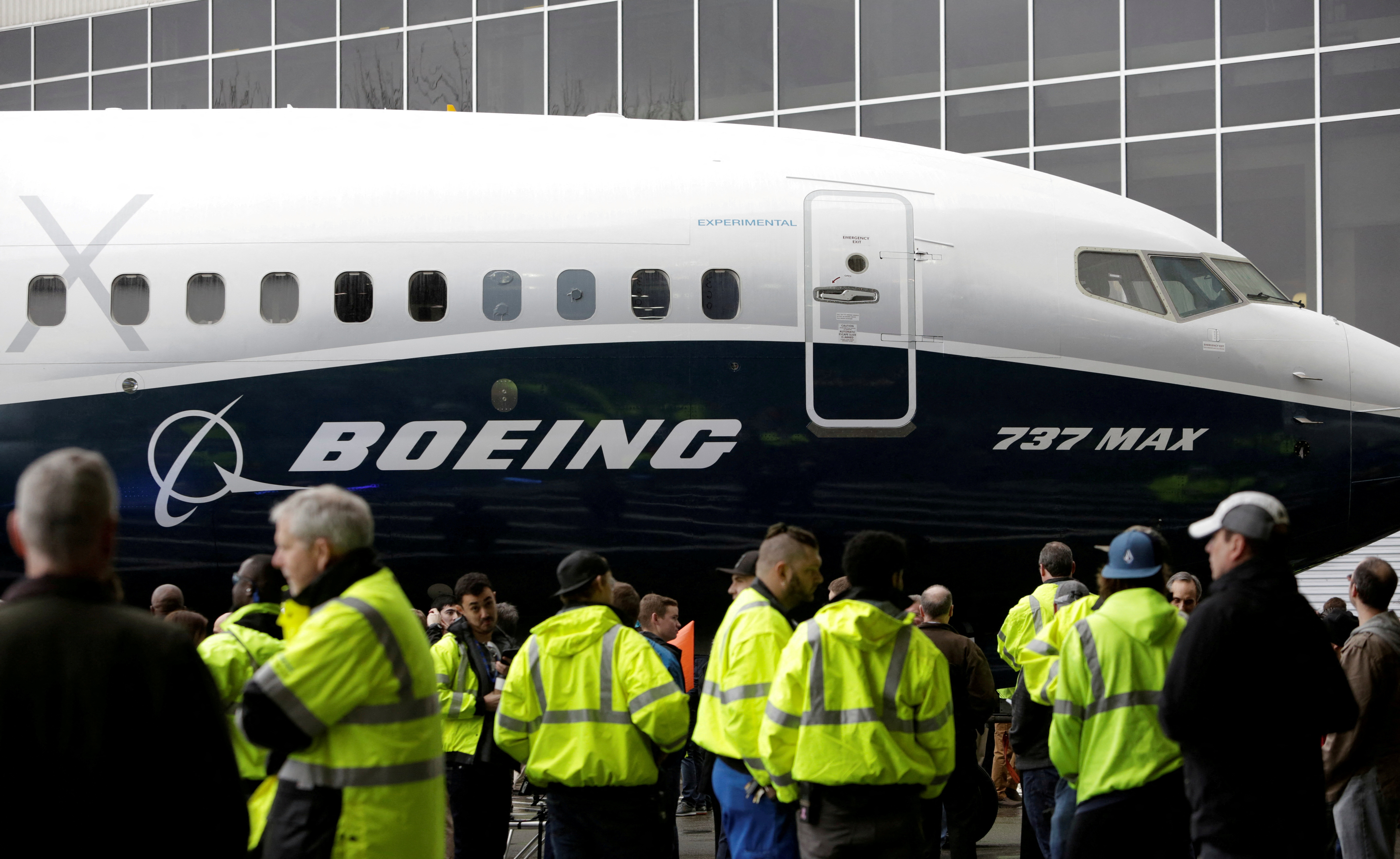 Employees are pictured as the first Boeing 737 MAX 7 is unveiled in Renton