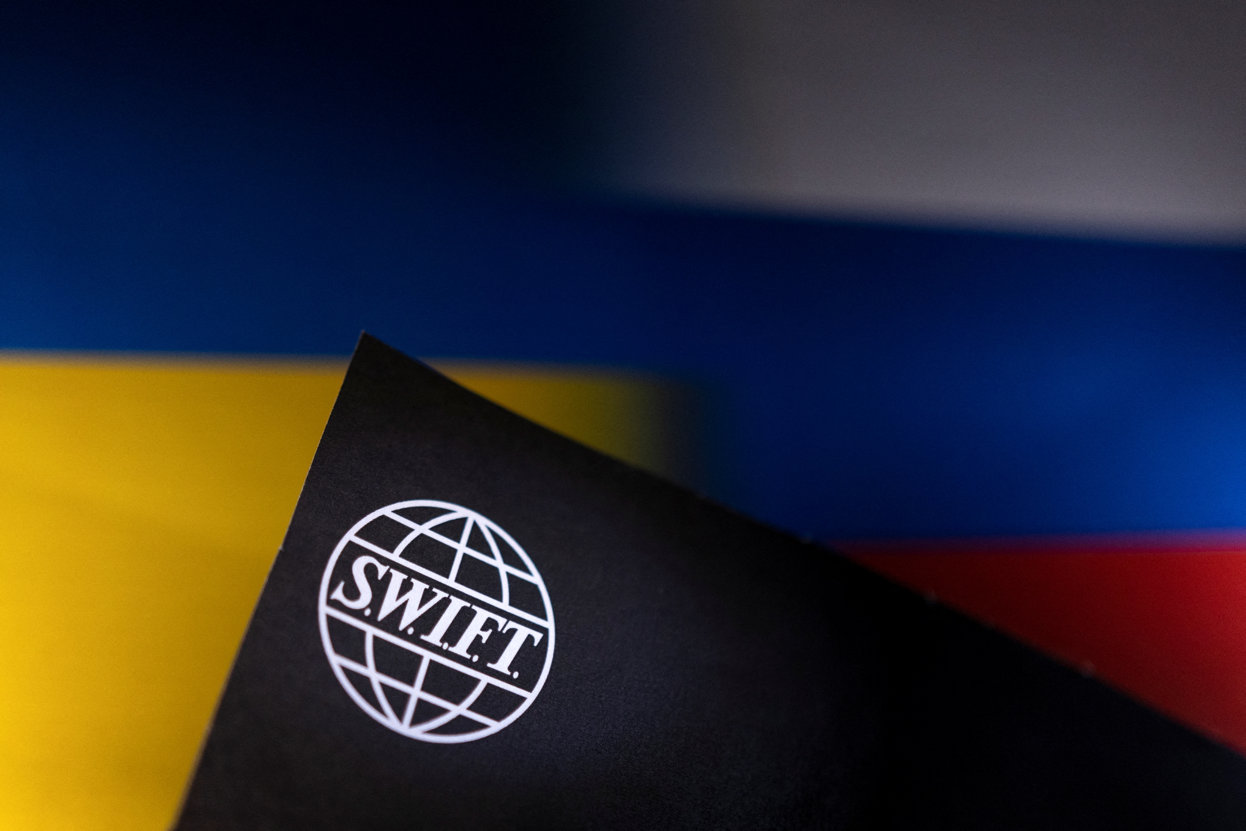 Illustration shows Swift logo placed on Ukrainian's and Russian's flag colors