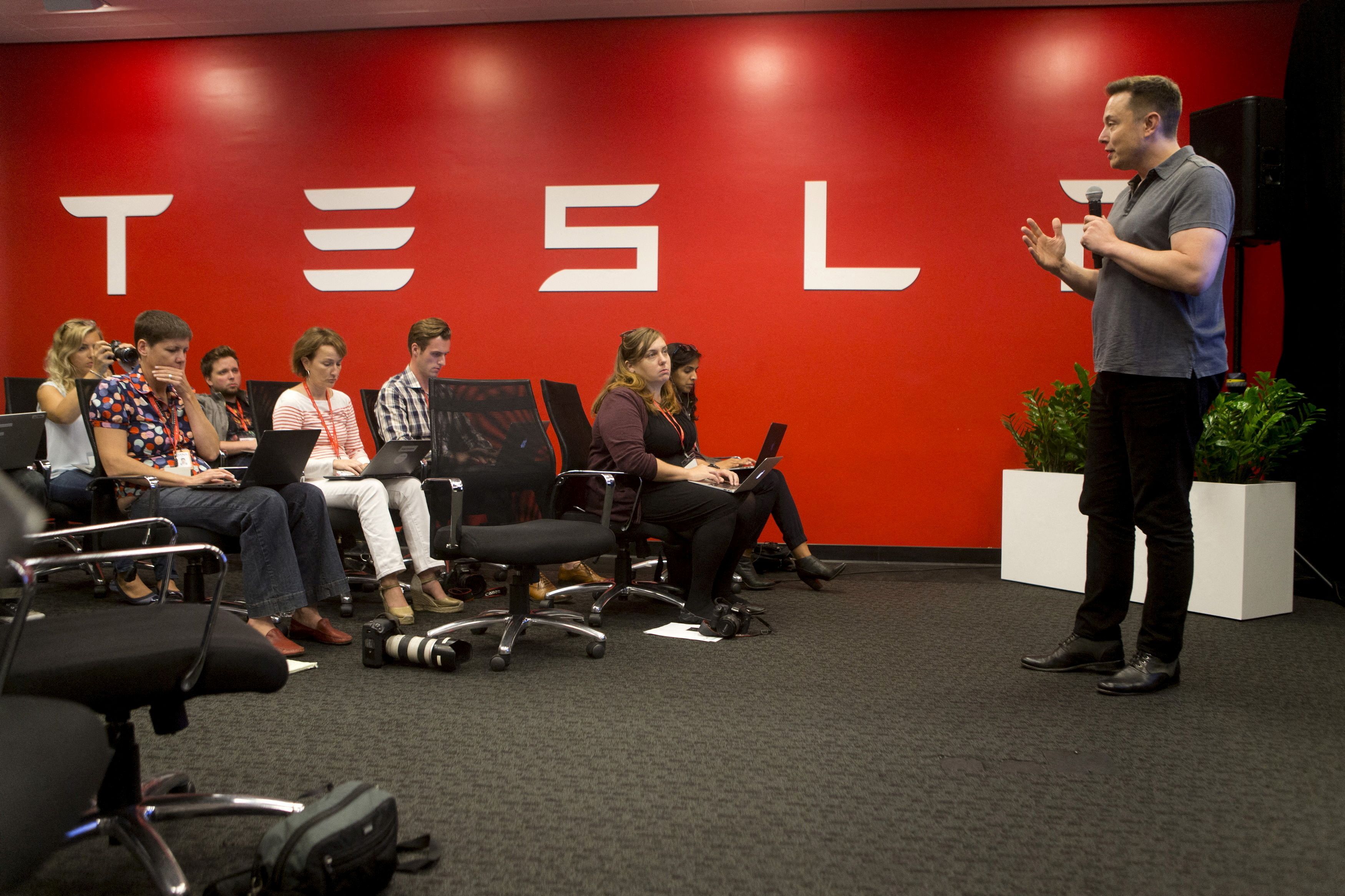 Tesla CEO Elon Musk speaks about new Autopilot features during a Tesla event in Palo Alto