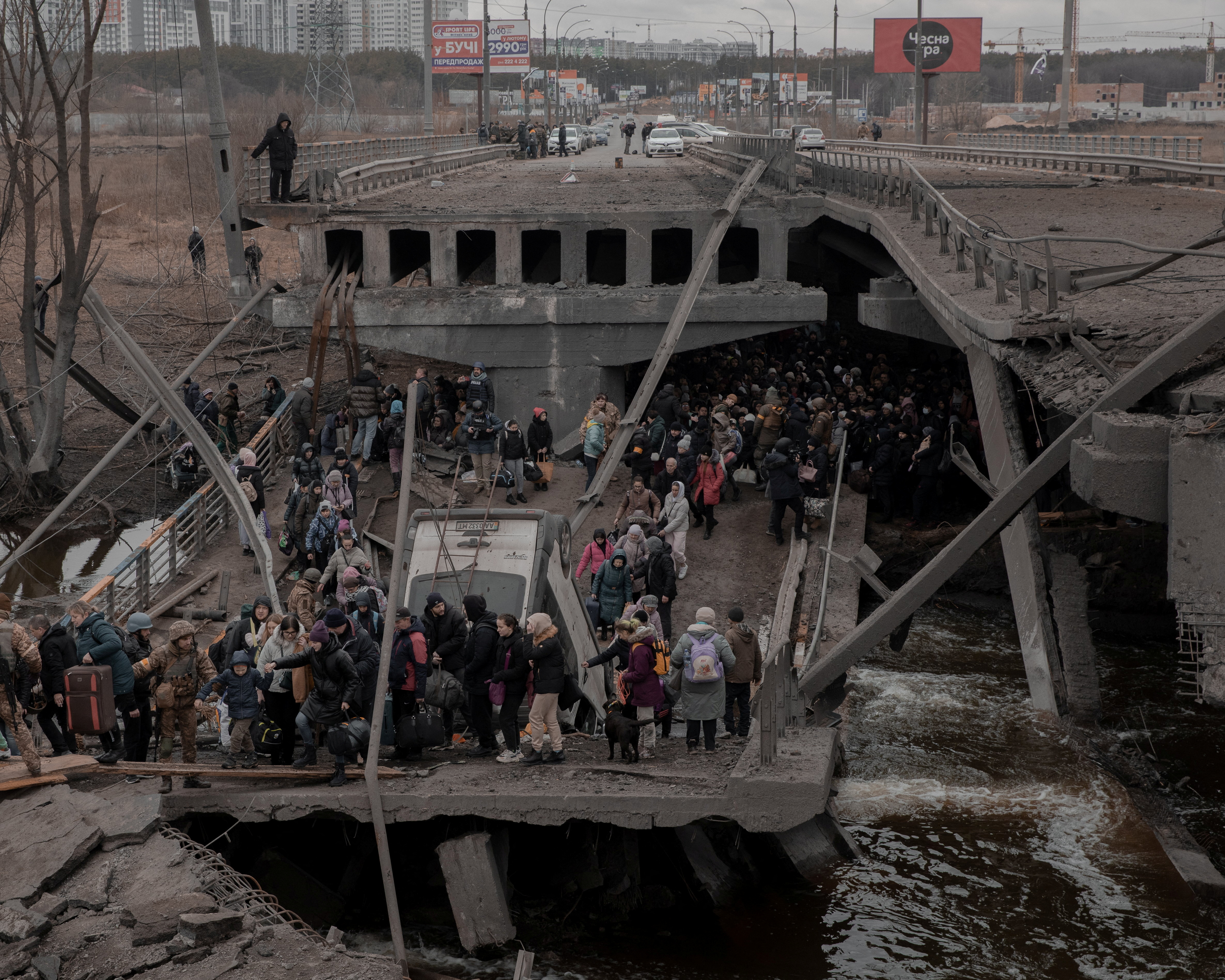 People flee from the city of Irpin in Kyiv region