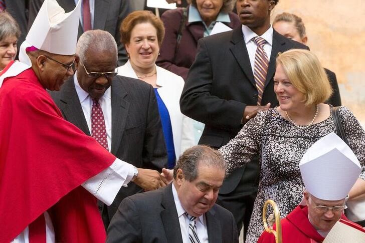 Virginia Thomas, wife of Justice Thomas, shakes hands with a member of the clergy as they exit the Red Mass at the Cathedral of St. Matthew the Apostle in Washington