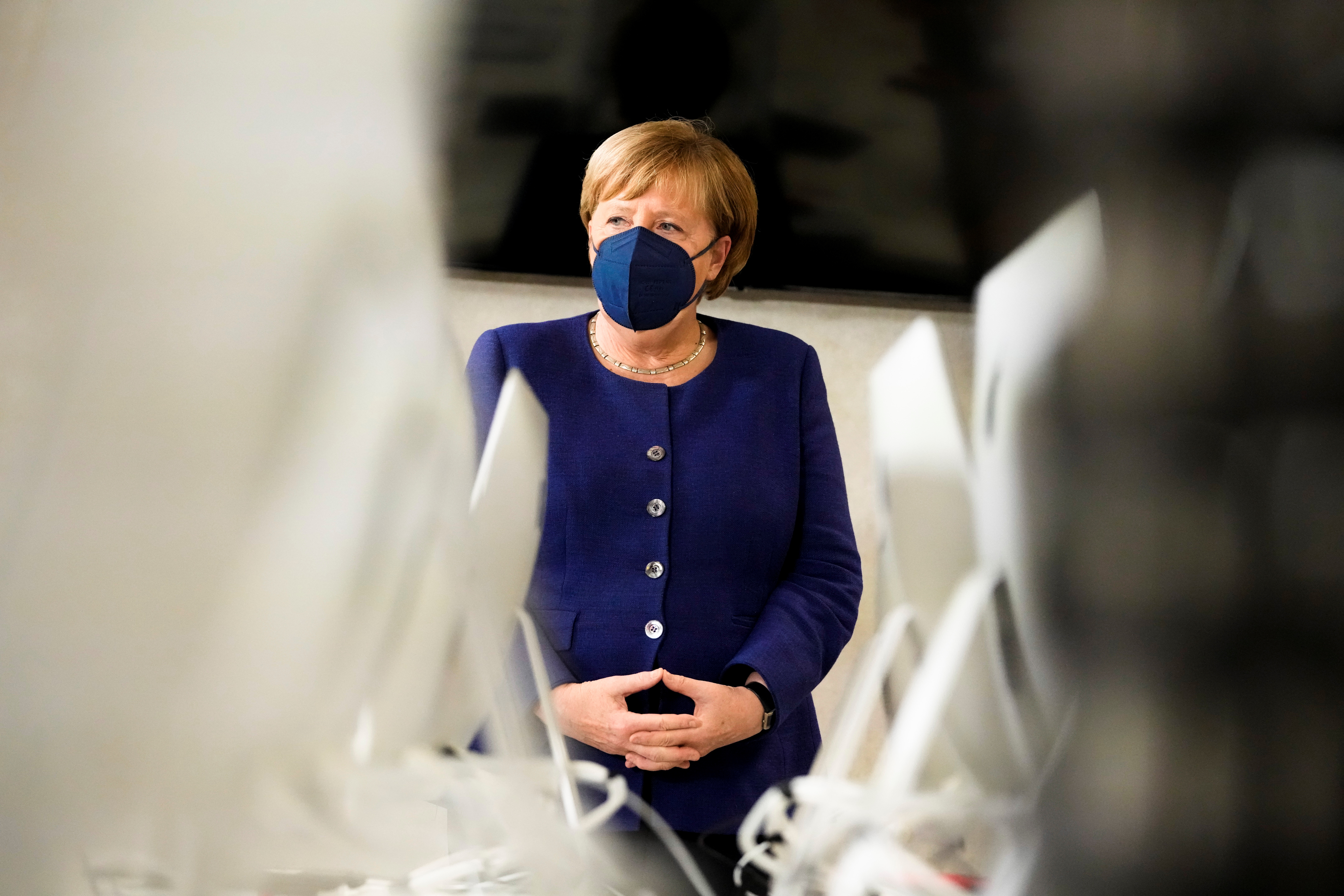 German Chancellor Angela Merkel listens to students during her visit at the TUMO Center for Creative Technologies, in Berlin, Germany, November 22, 2021. Markus Schreiber/Pool via REUTERS