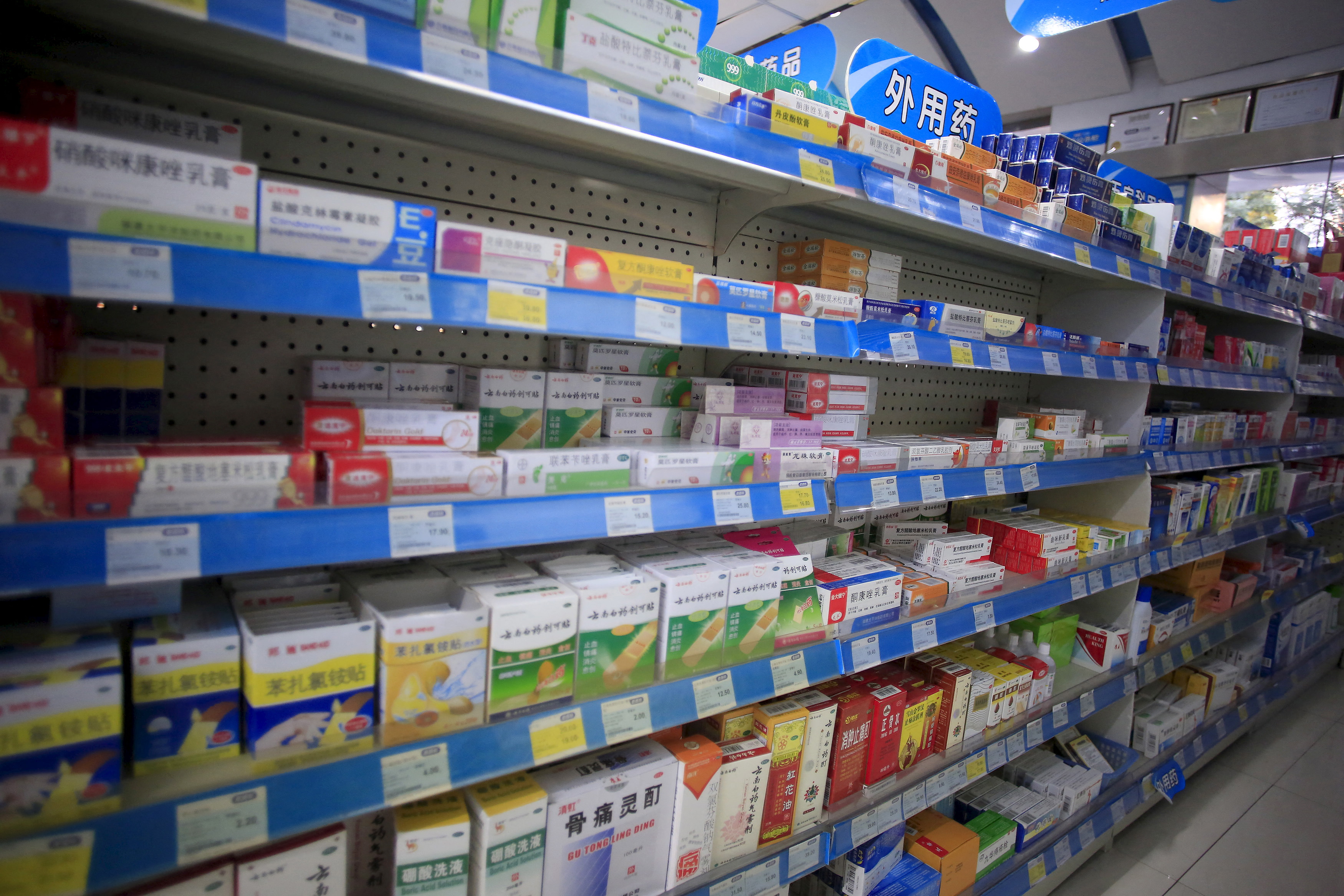 Shelves displaying medicines are seen at a pharmacy in Shanghai