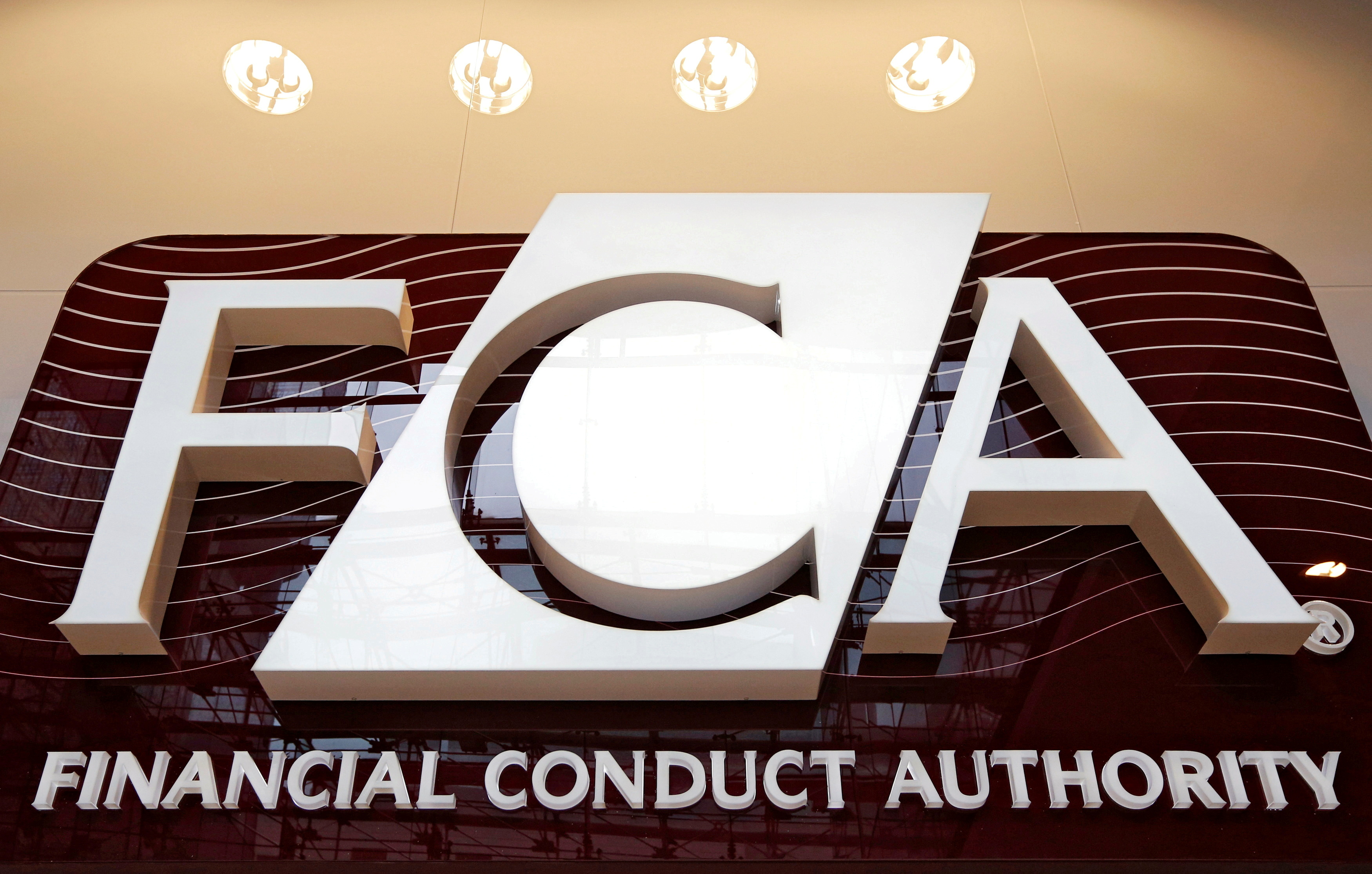 The logo of the new Financial Conduct Authority is seen at the agency's headquarters in the Canary Wharf business district of London