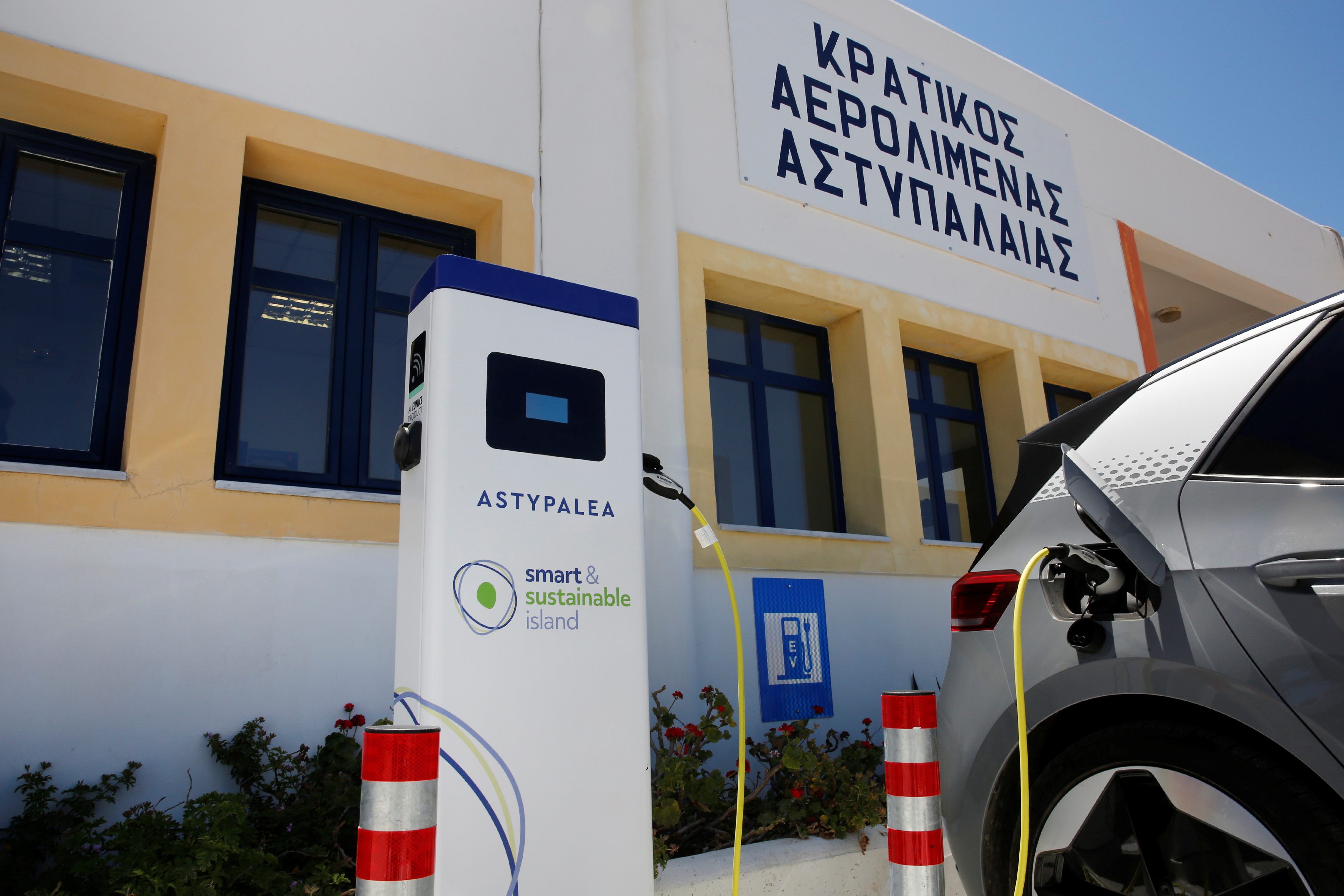 A Volkswagen ID.4 electric car is charged at the airport on the island of Astypalea