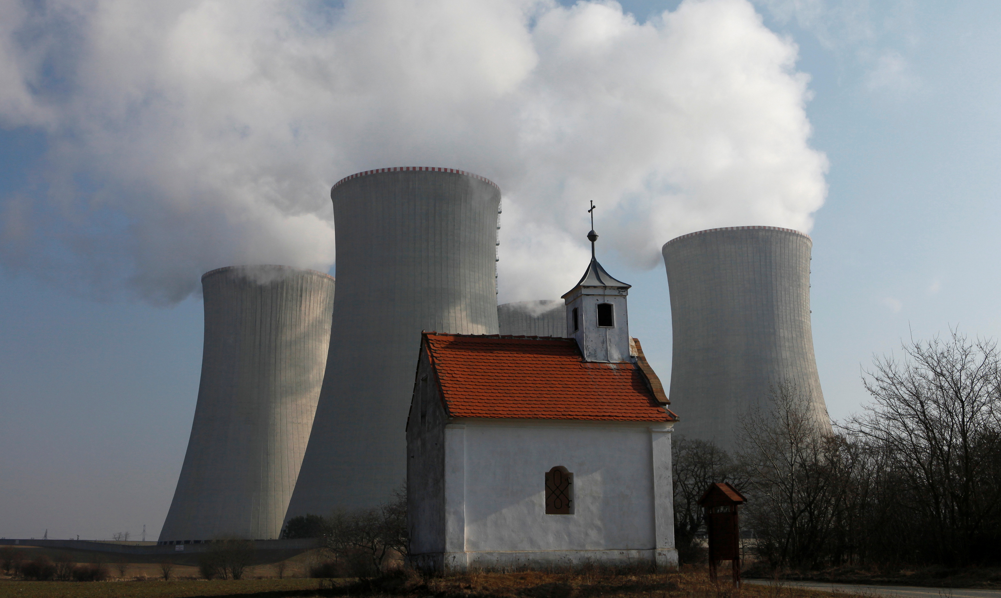 A chapel is seen in front of the cooling towers of the Czech nuclear power plant at Dukovany