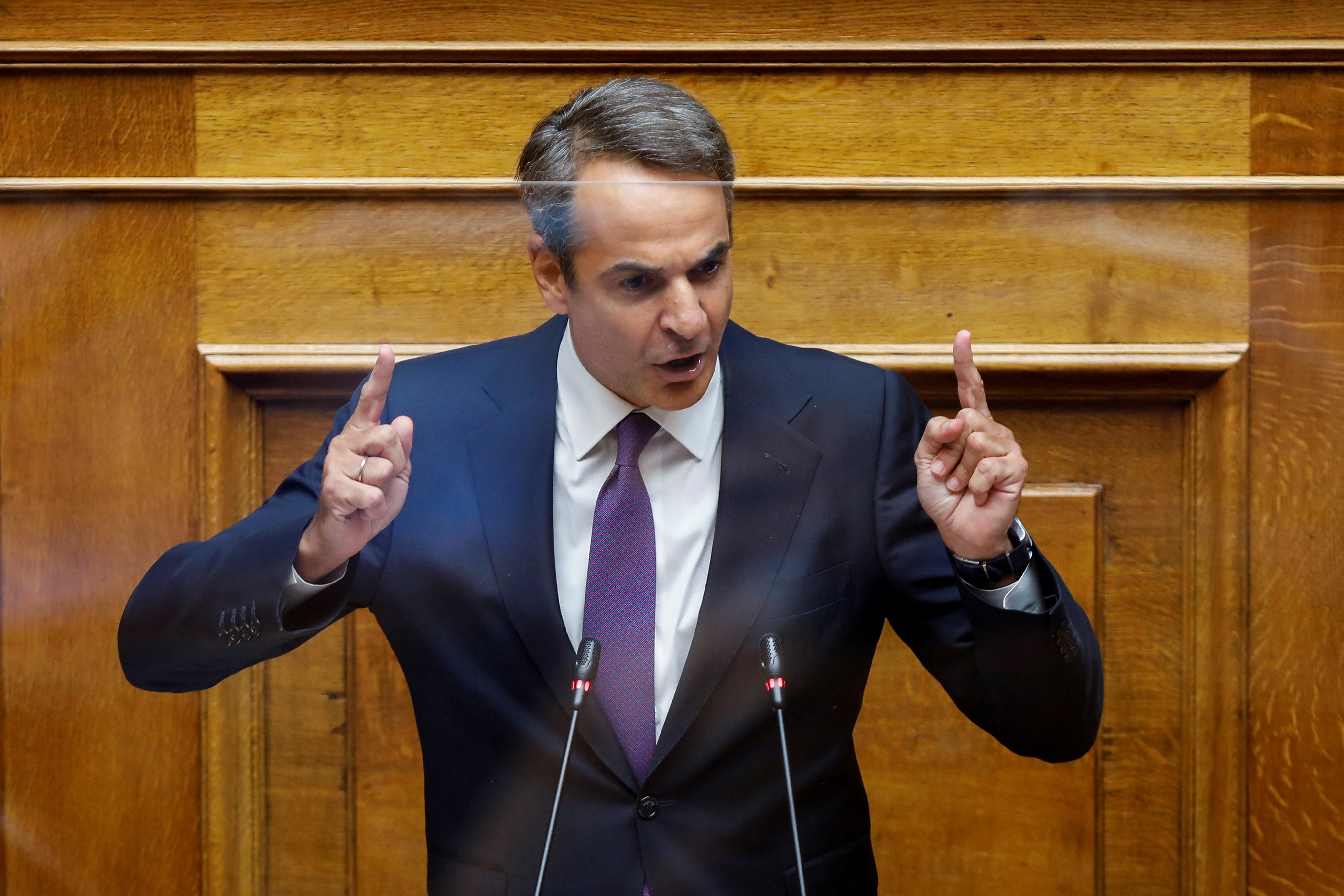 Greek PM Mitsotakis addresses lawmakers during a parliamentary on a wiretapping case in Athens