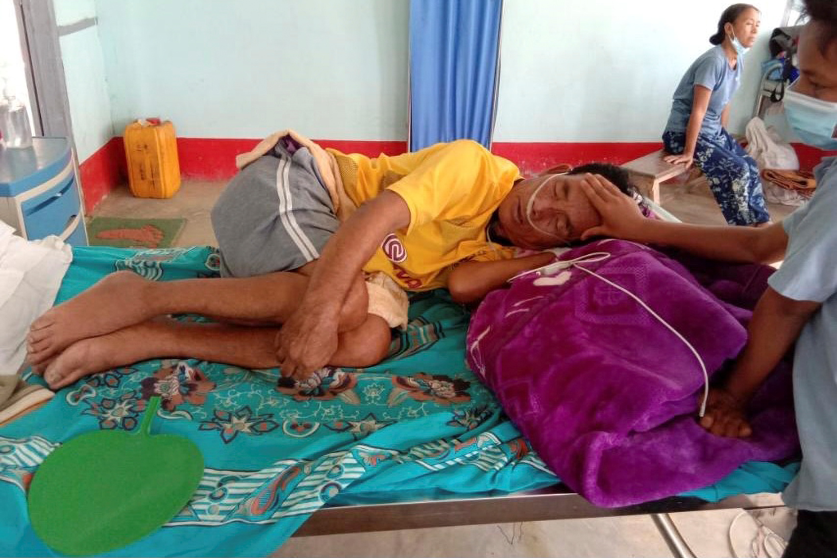 A COVID-19 patient lies in bed at the hospital in Cikha