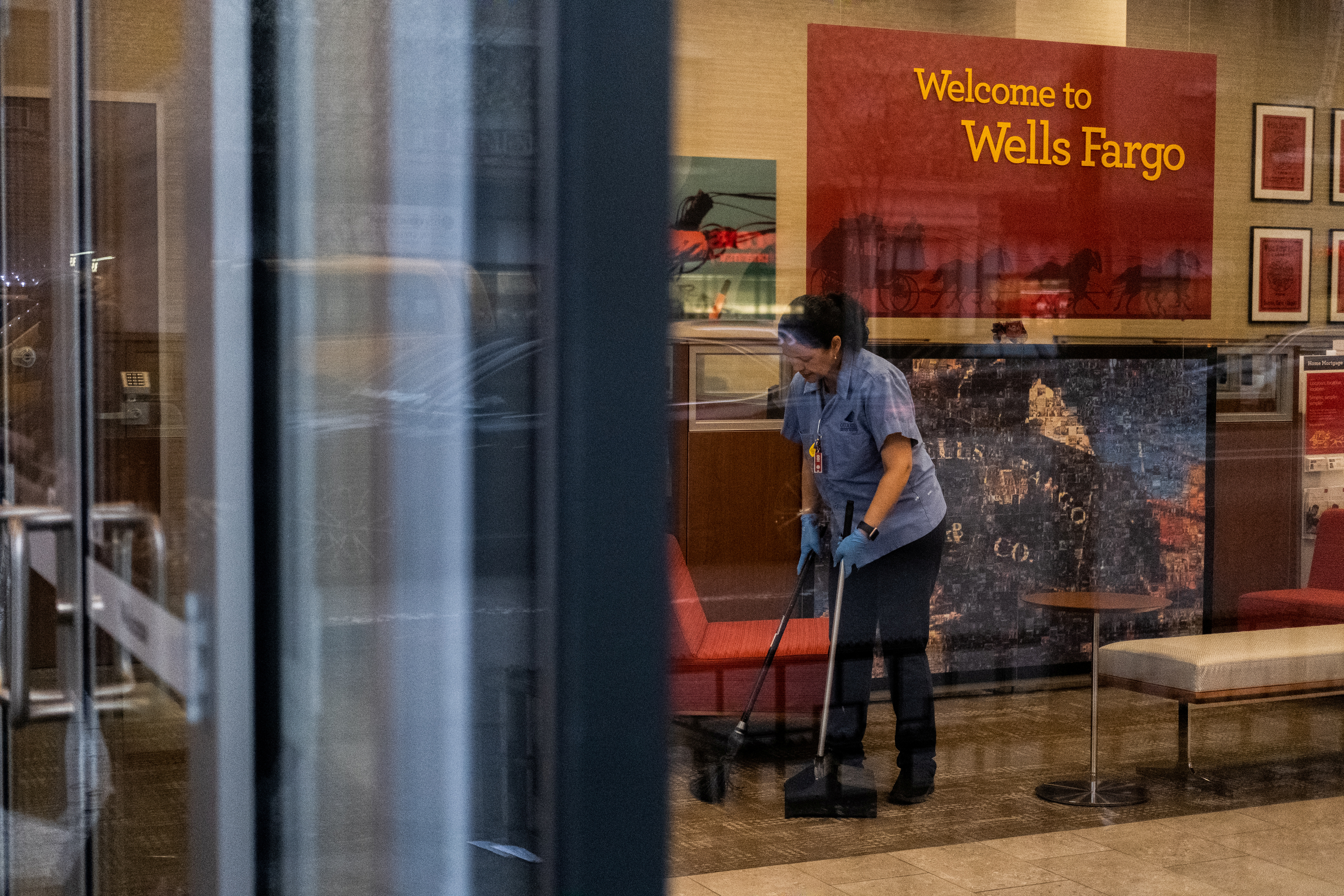 A staff cleans the lobby inside Wells Fargo bank in New York