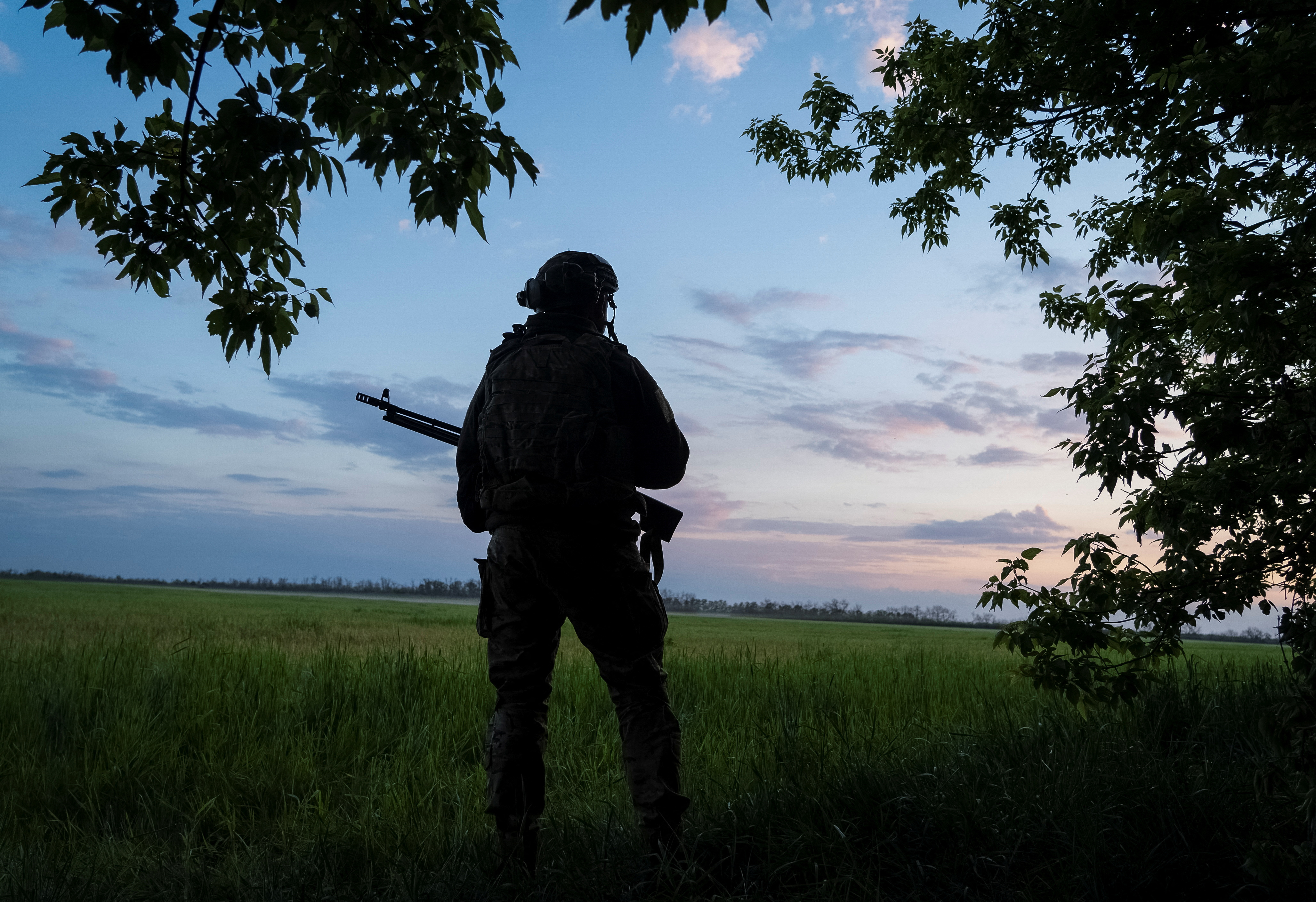 A Ukrainian serviceman guards an area near the town of Vovchansk