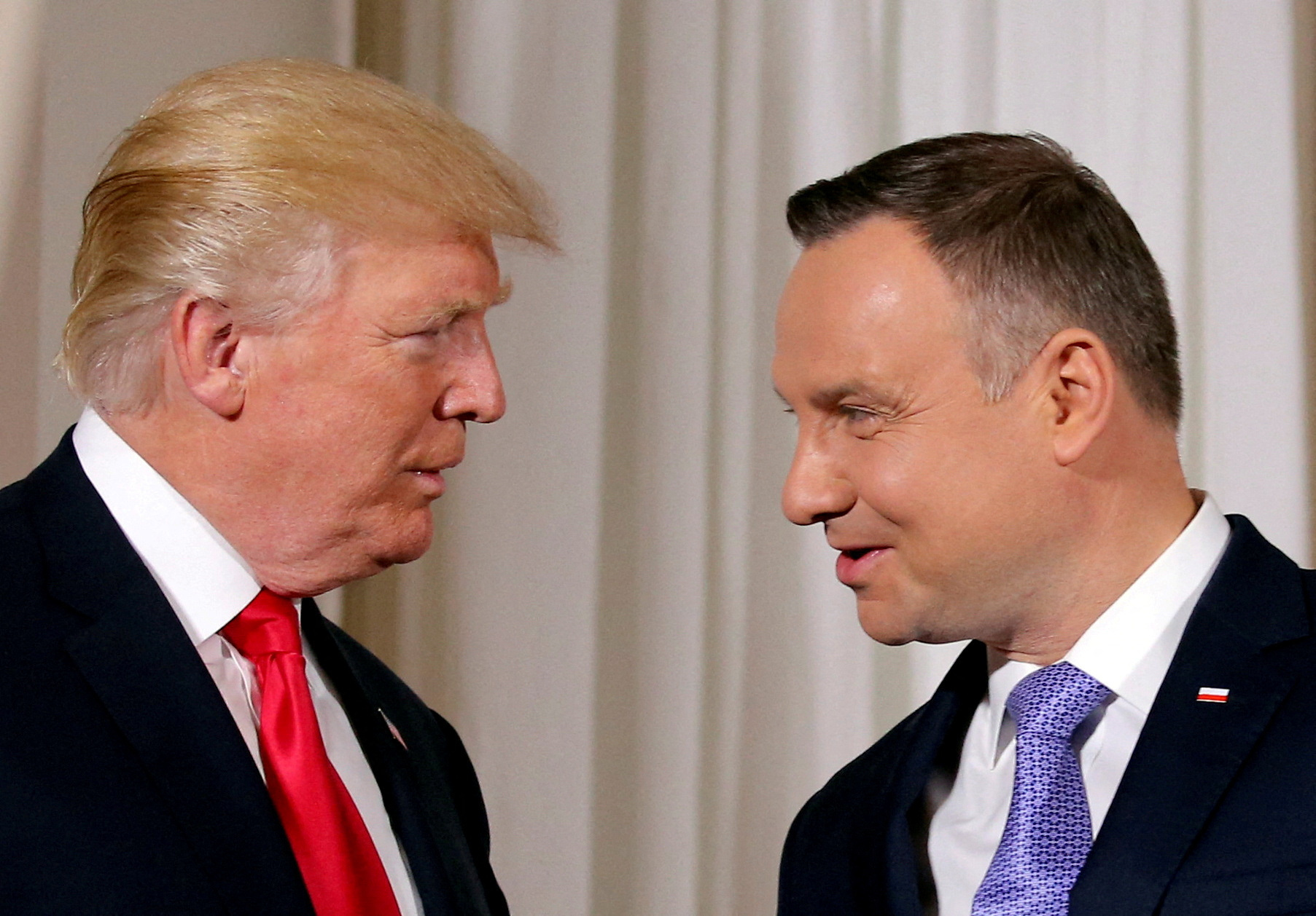 U.S. President Donald Trump is greeted by Polish President Andrzej Duda in Warsaw