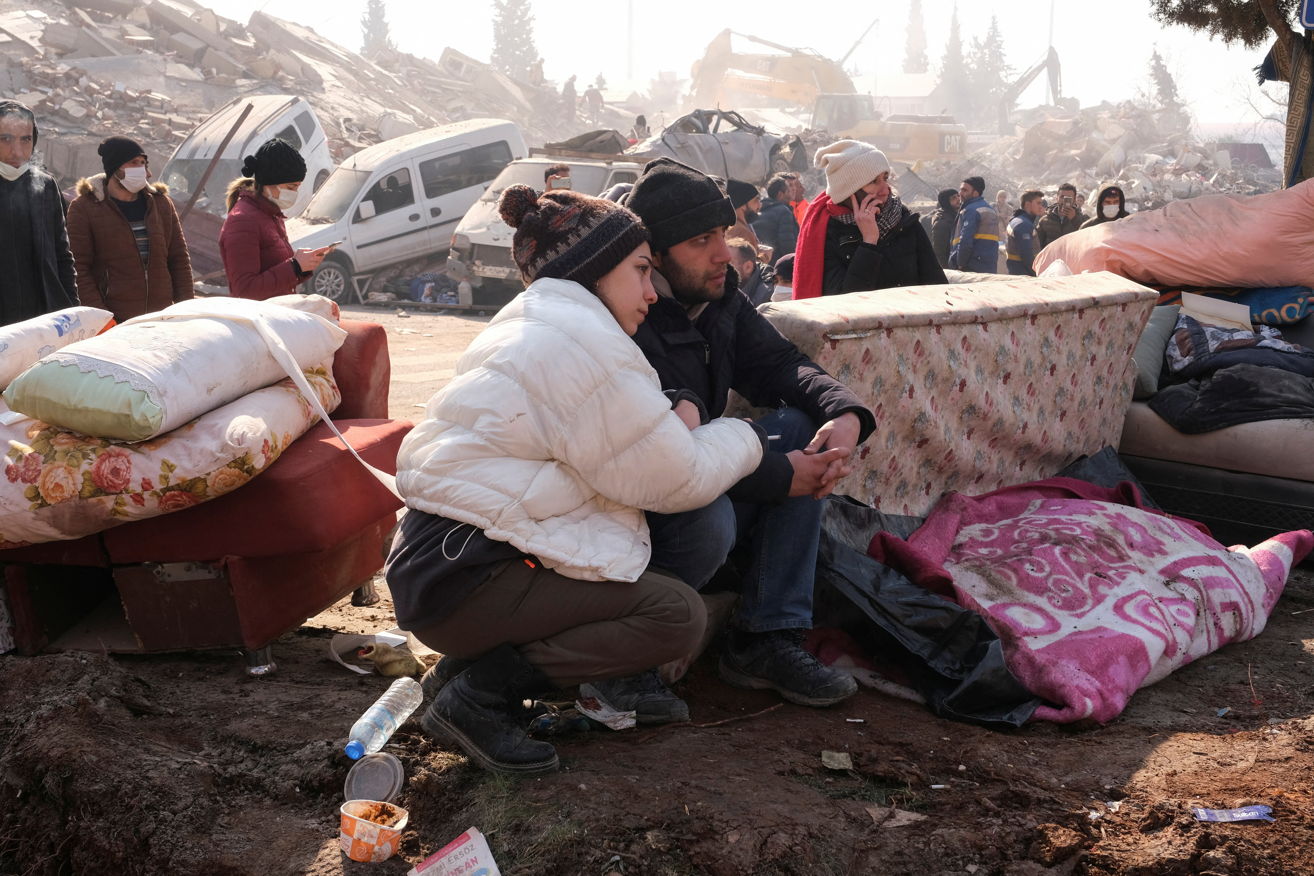 Married couple wait to find out if their loved ones is still alive, following the deadly earthquake in Maras