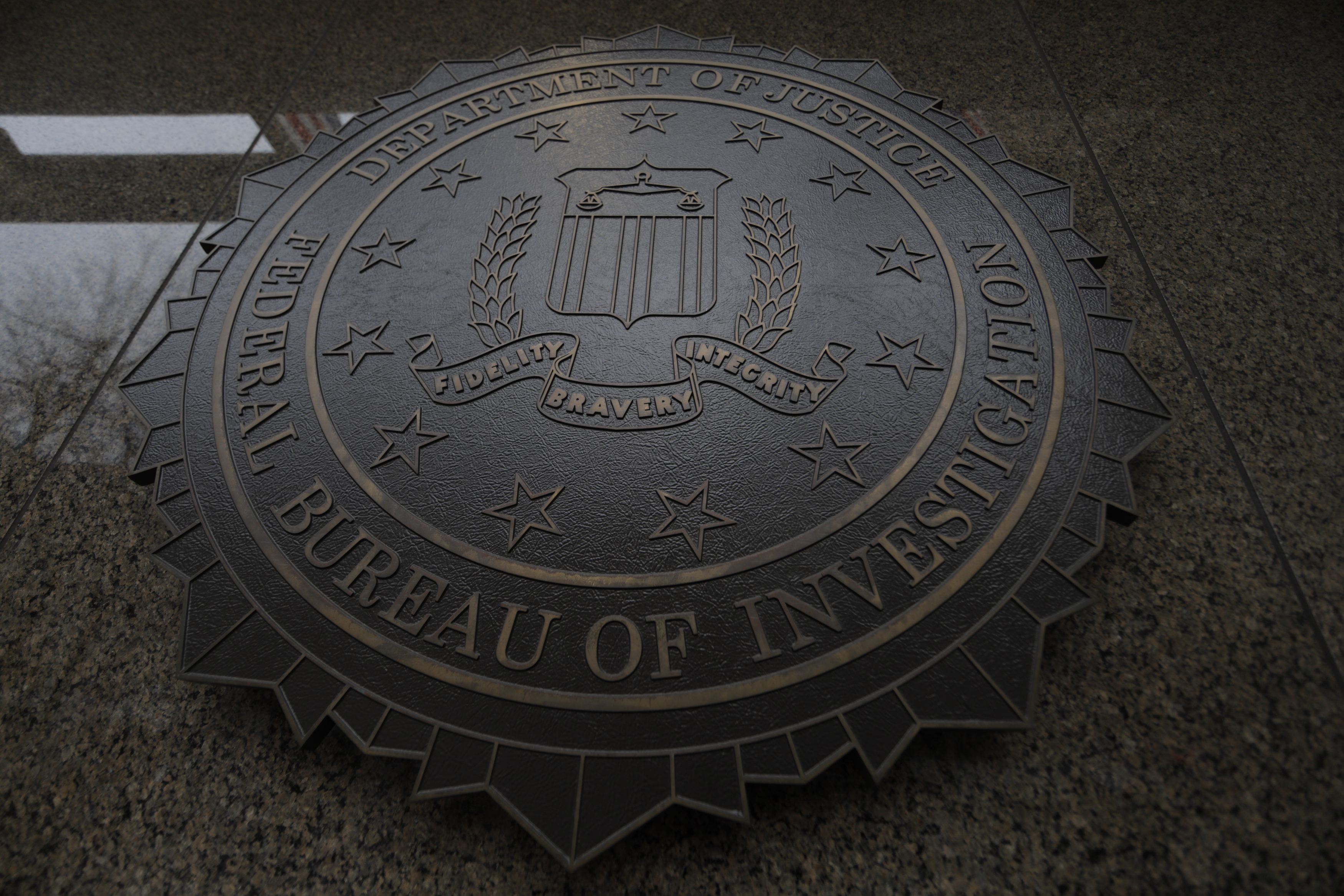The FBI seal and motto are seen at of the J. Edgar Hoover Federal Bureau of Investigation (FBI) Building in Washington, U.S., February 1, 2018.  REUTERS/Jim Bourg