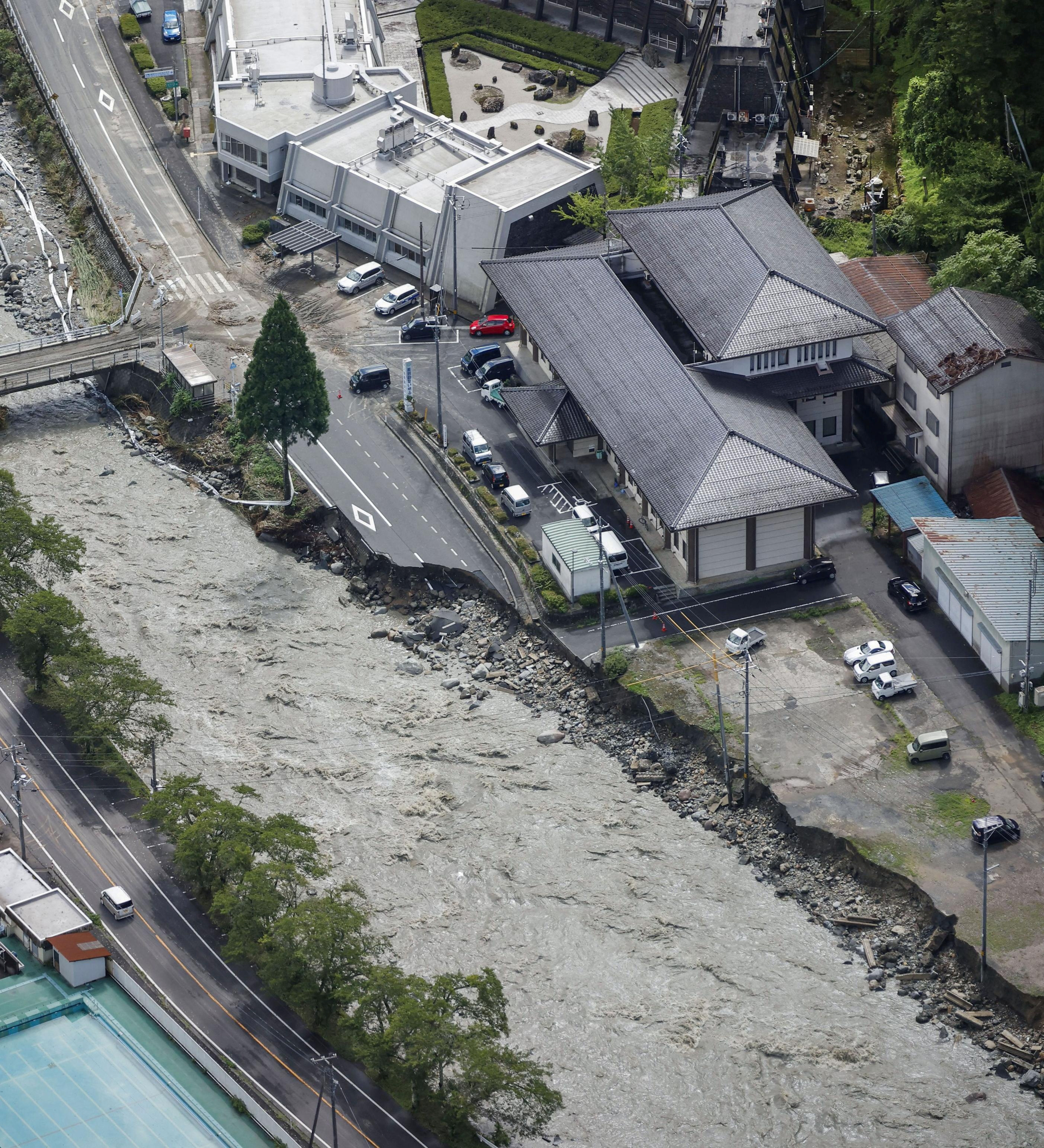 A collapsed road near the Saji River is pictured in Tottori
