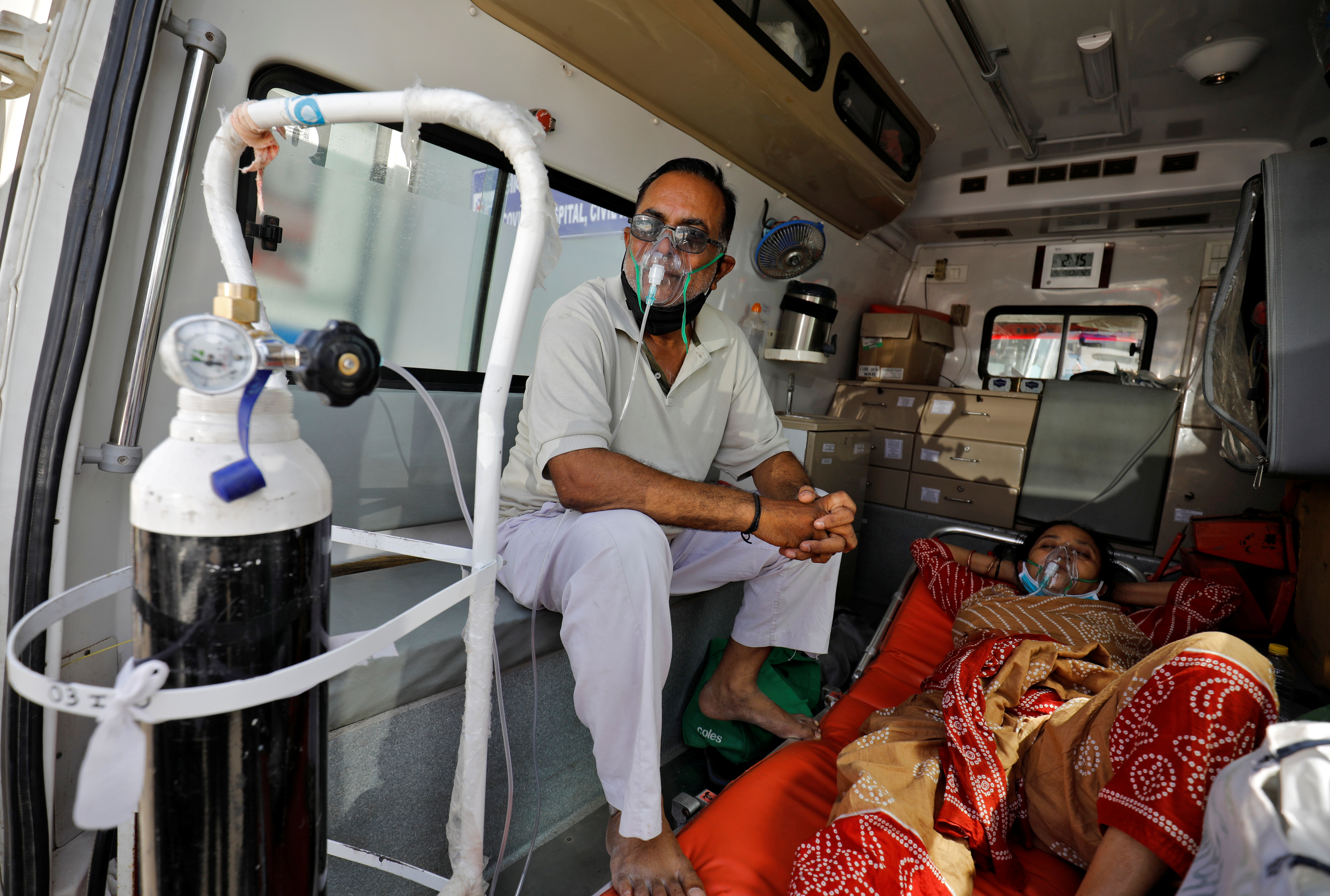 Patients with breathing problem wait inside an ambulance to enter a COVID-19 hospital for treatment, in Ahmedabad