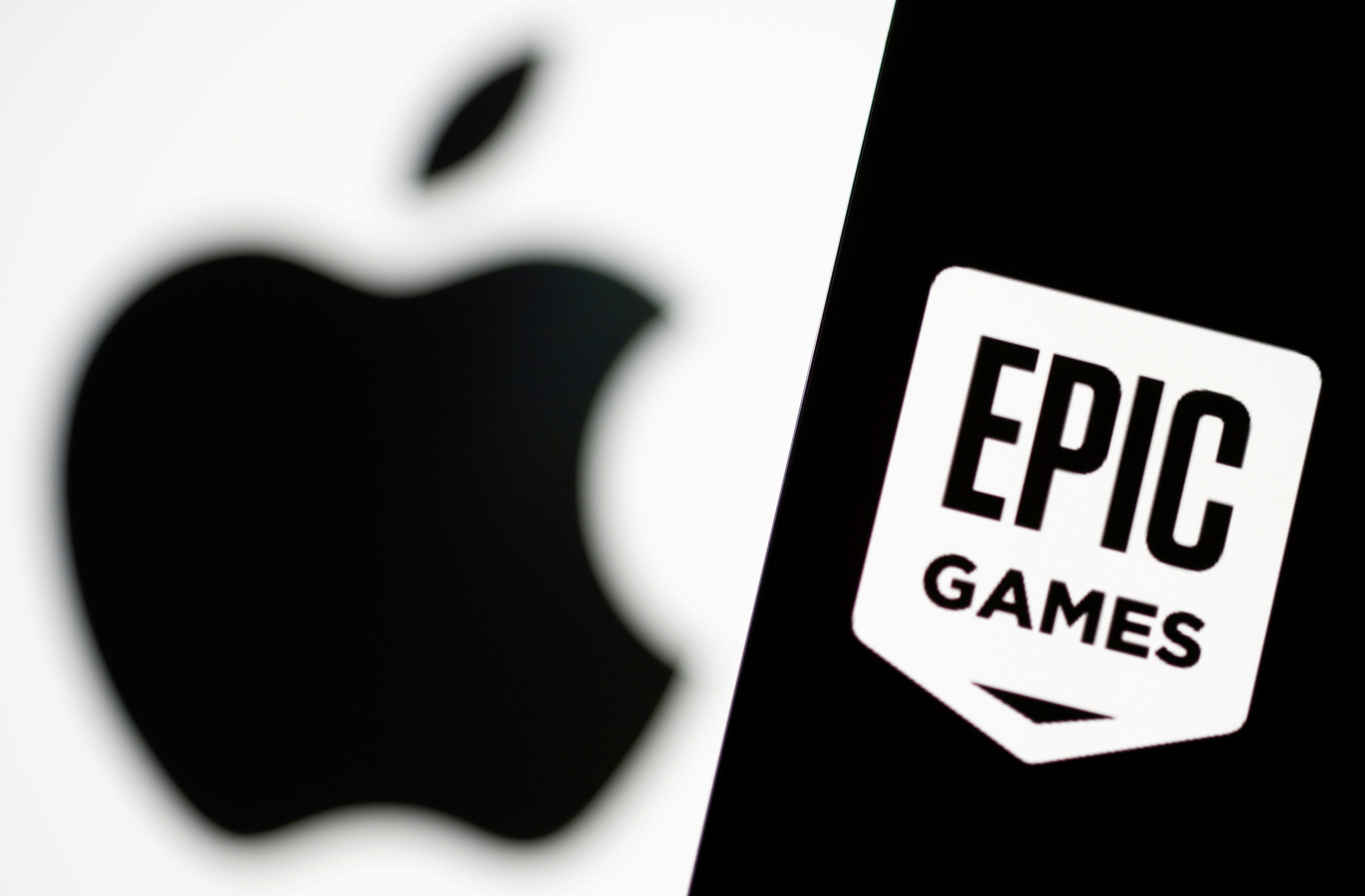 Smartphone with Epic Games logo is seen in front of Apple logo in this illustration