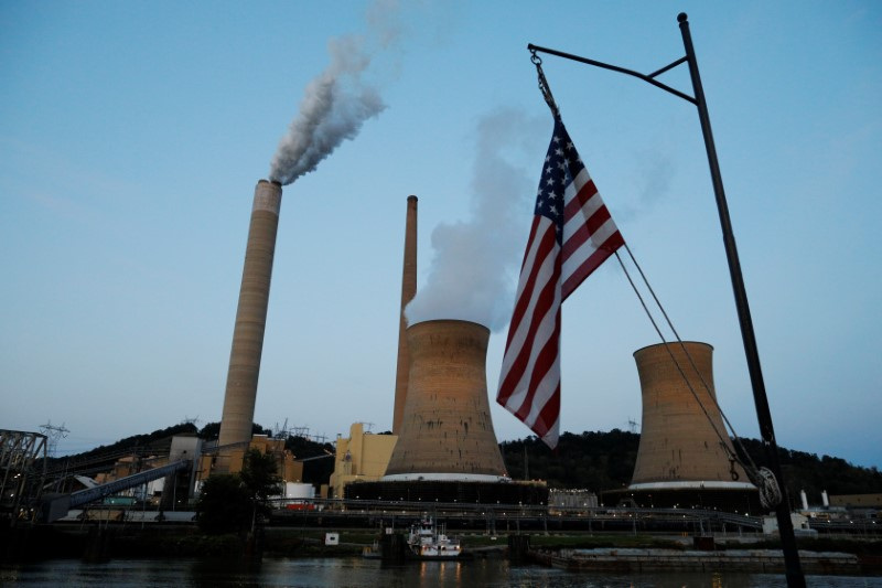 The U.S. flag flies on Campbell Transportation's towboat M.K. McNally as it passes Mitchell Power Plant on the Ohio River in Moundsville