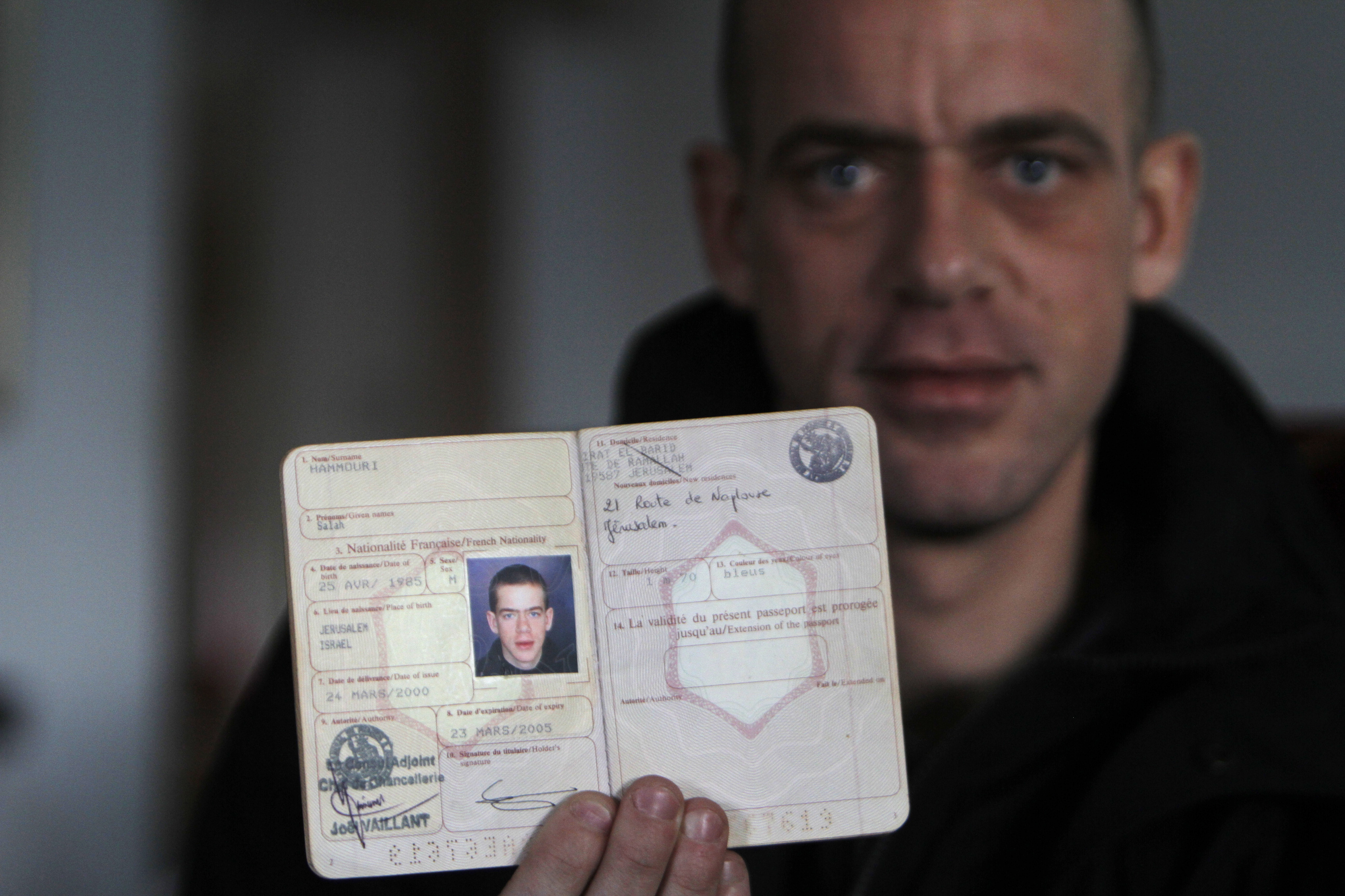 Hamouri shows his French passport during an interview with Reuters near Jerusalem