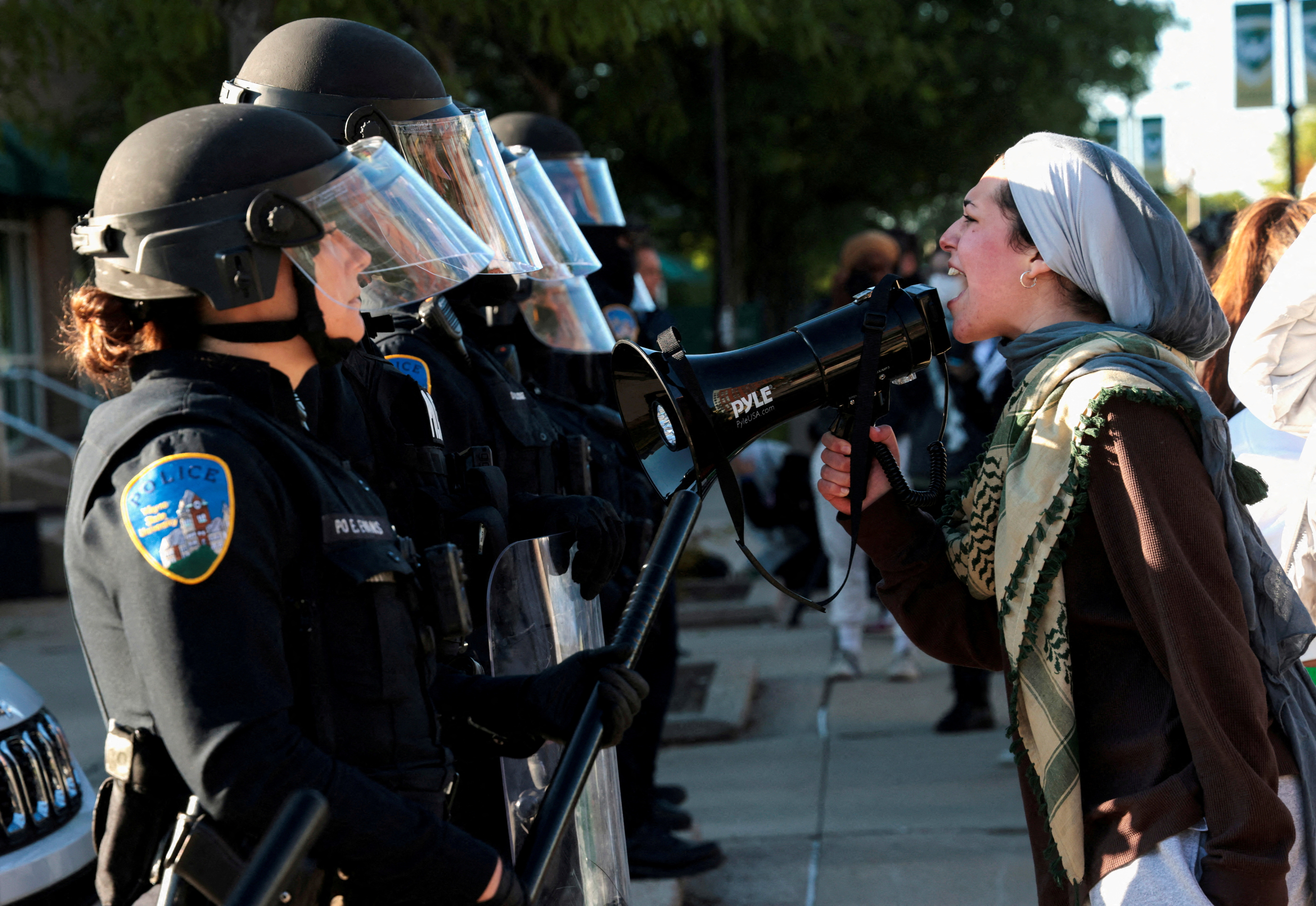 A Pro-Palestinian protestor faces off with Wayne State University police, in Detroit