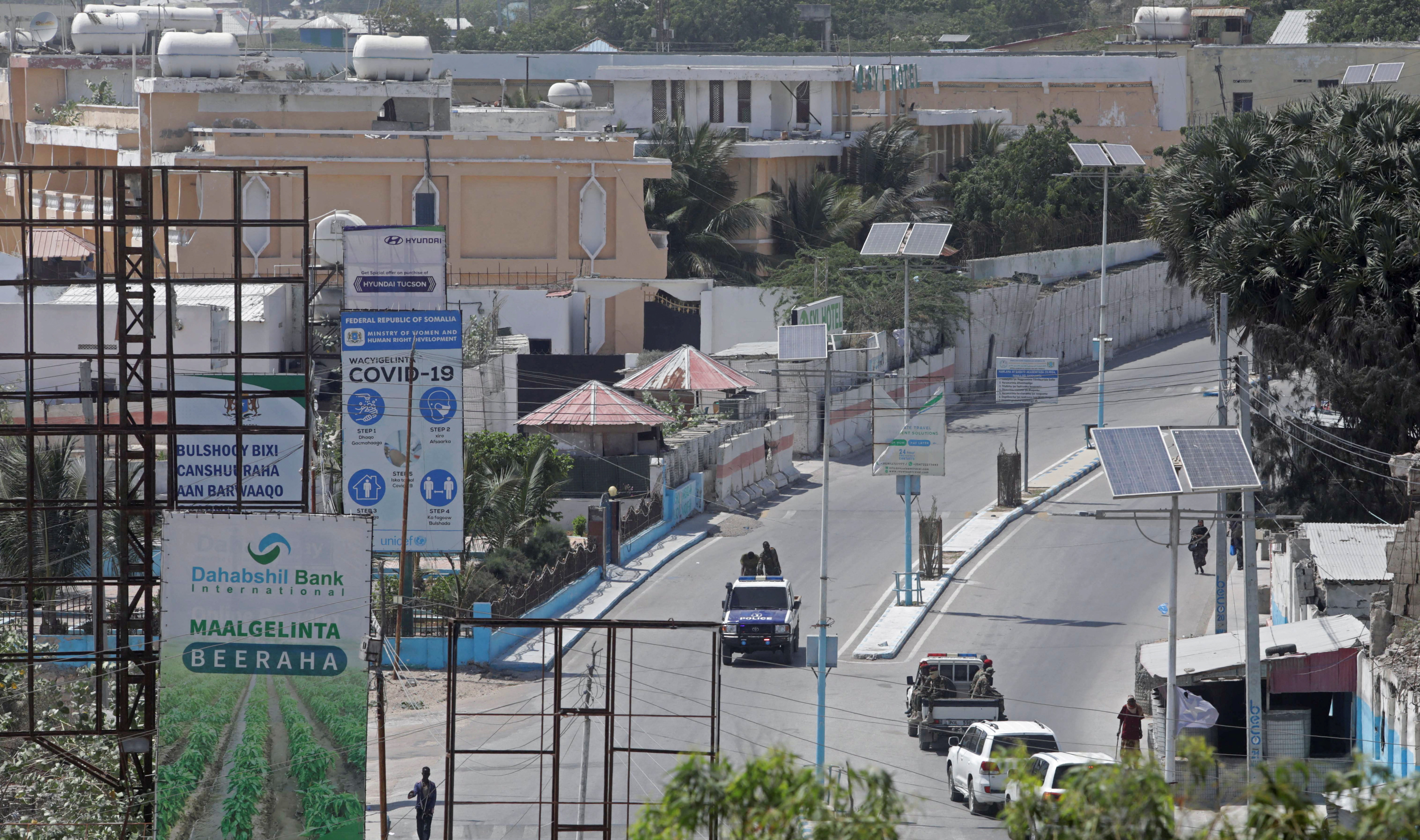A Somali police truck drive along the empty street in front of the Presidential palace in Mogadishu