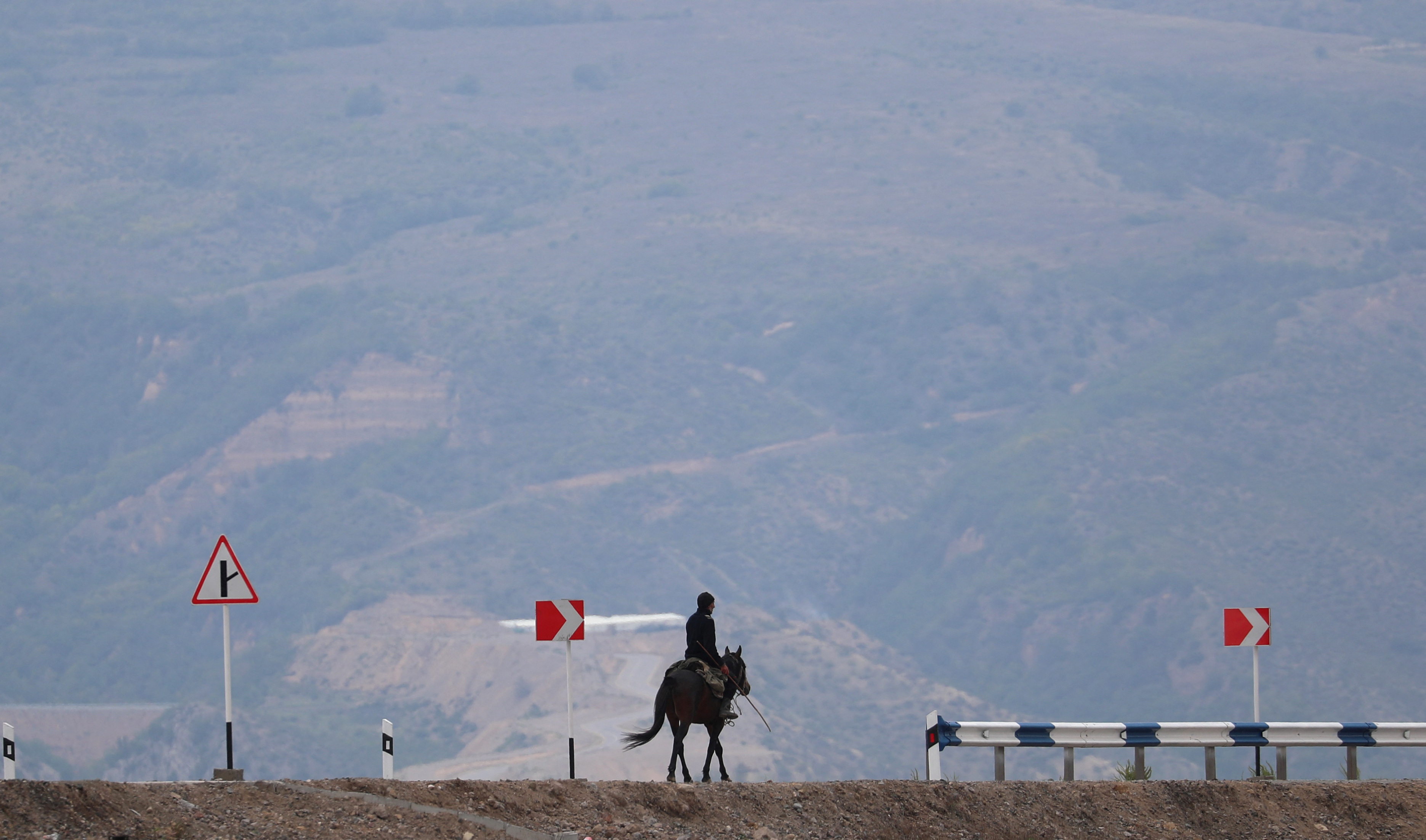 A man rides a horse near the Armenia-Azerbaijan border
